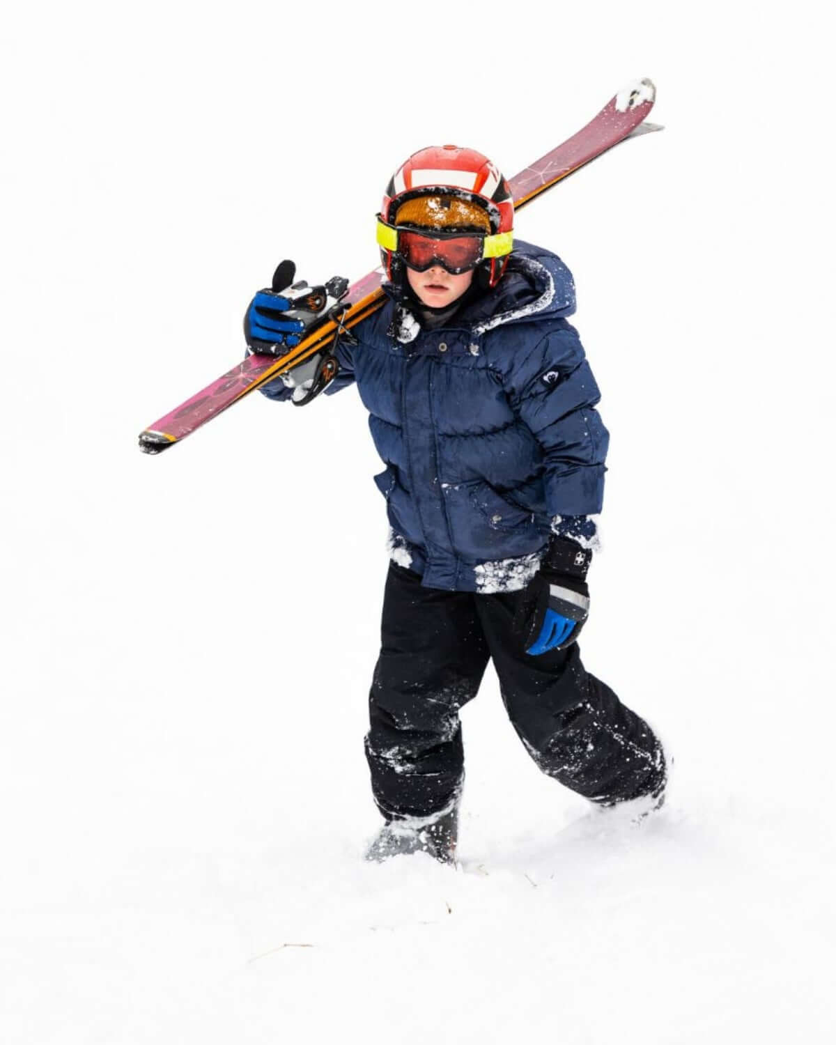 Cool kid in stylish ski gear conquering snowy slopes, rocking kids clothes with confidence for adventurous winter fun!