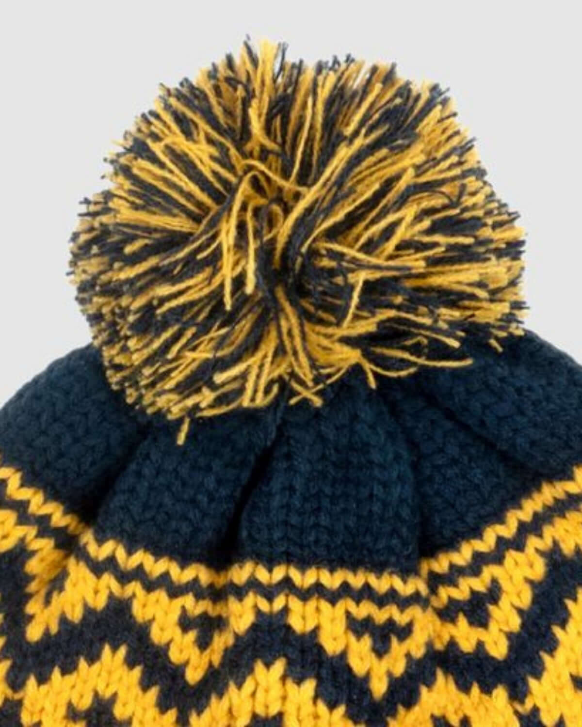Top view of a Navy Blue Bush Hat with a playful pompom design and chunky knit texture.