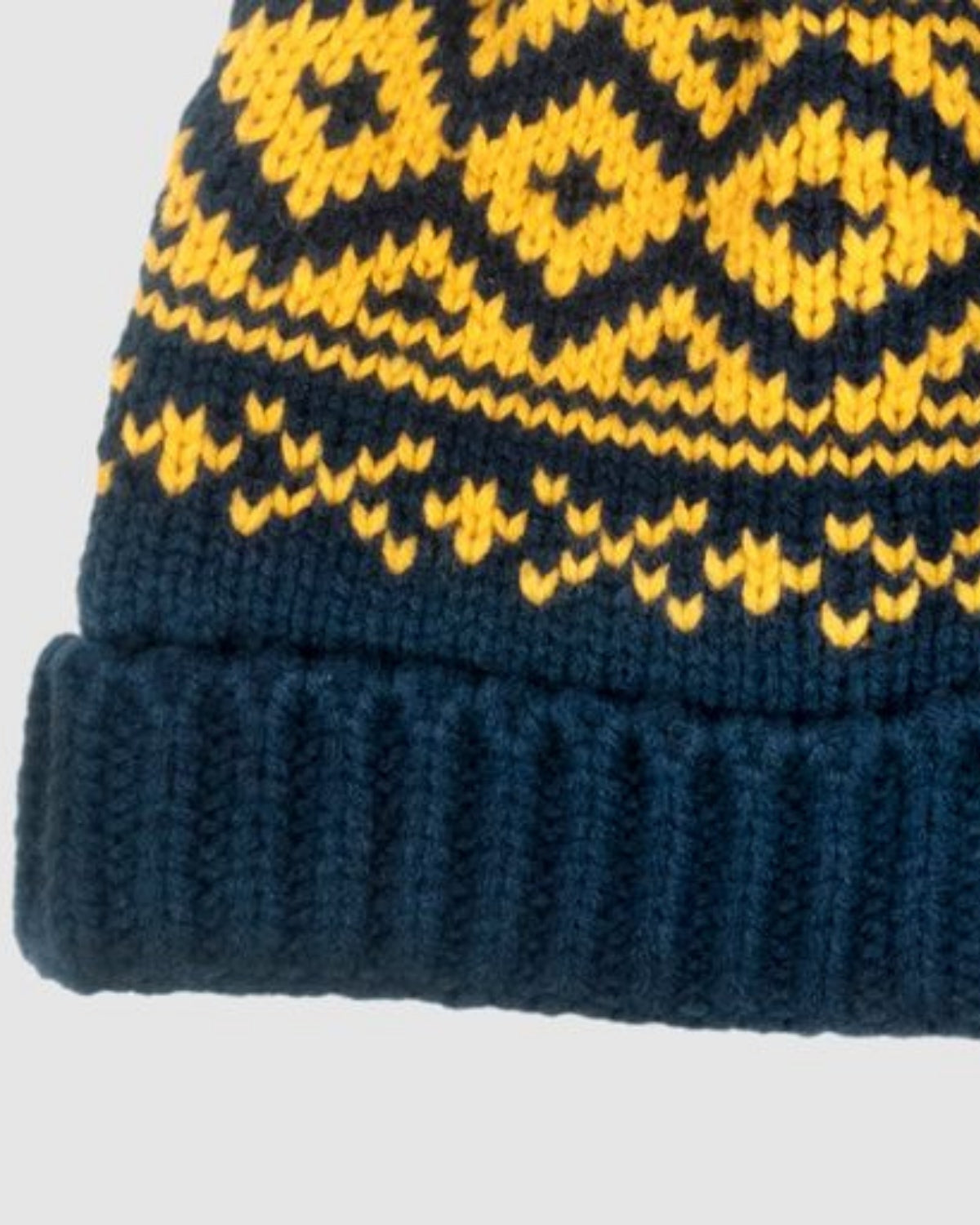 Navy blue knit bush hat with playful yellow patterns, keeping kids stylish and warm all winter long.