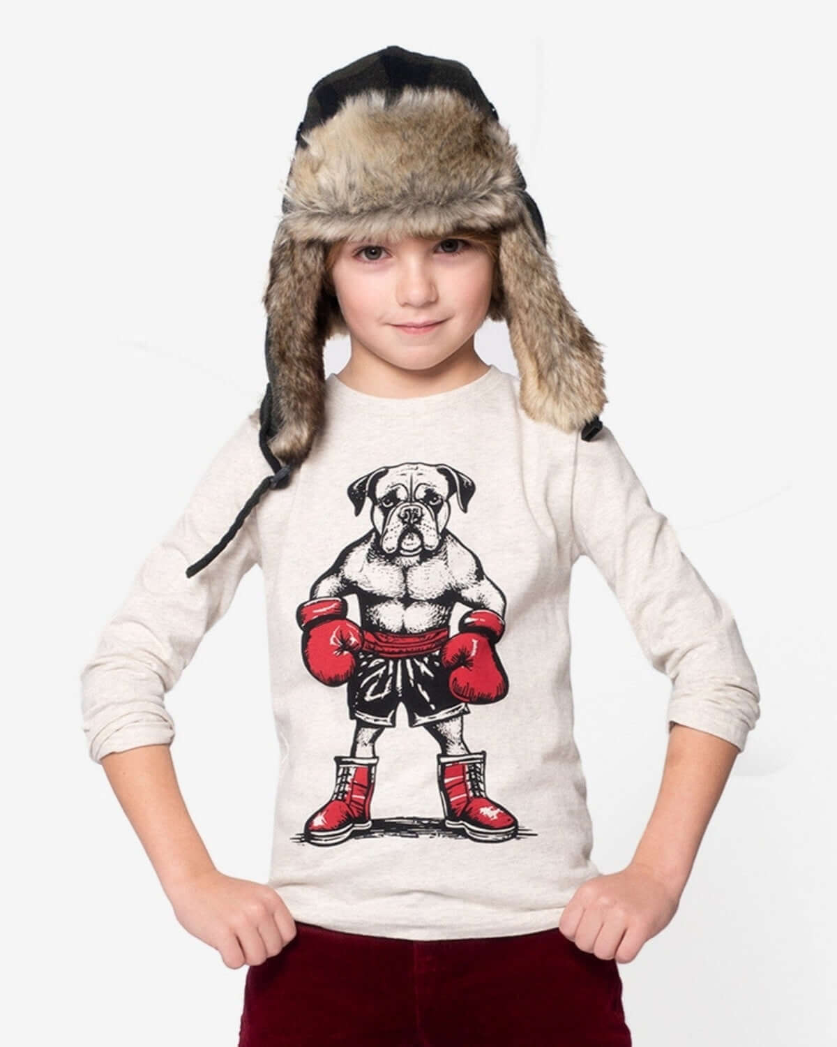 Stylish kid flaunting a playful pug boxer tee and cozy faux fur trapper hat—perfect for cool adventures!