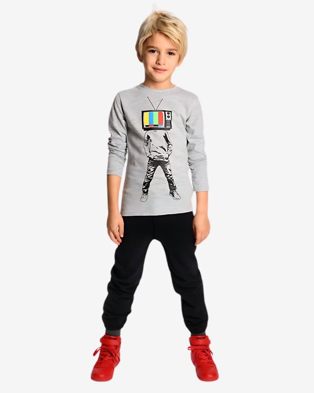 Stylish kid in playful TV graphic tee and comfy black sweatpants, ready for fun and adventures in high-quality kids clothes.
