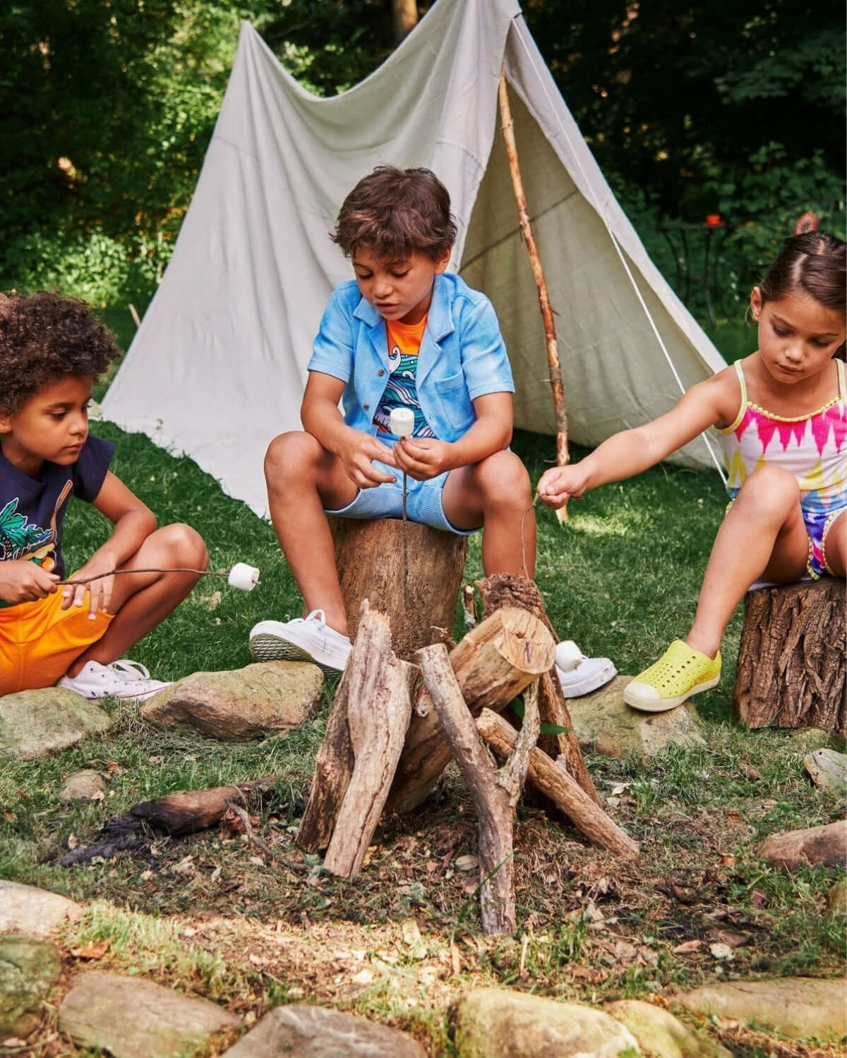 Kids in vibrant outdoor outfits enjoying camping fun, roasting marshmallows by the fire! Perfect for summer adventures.