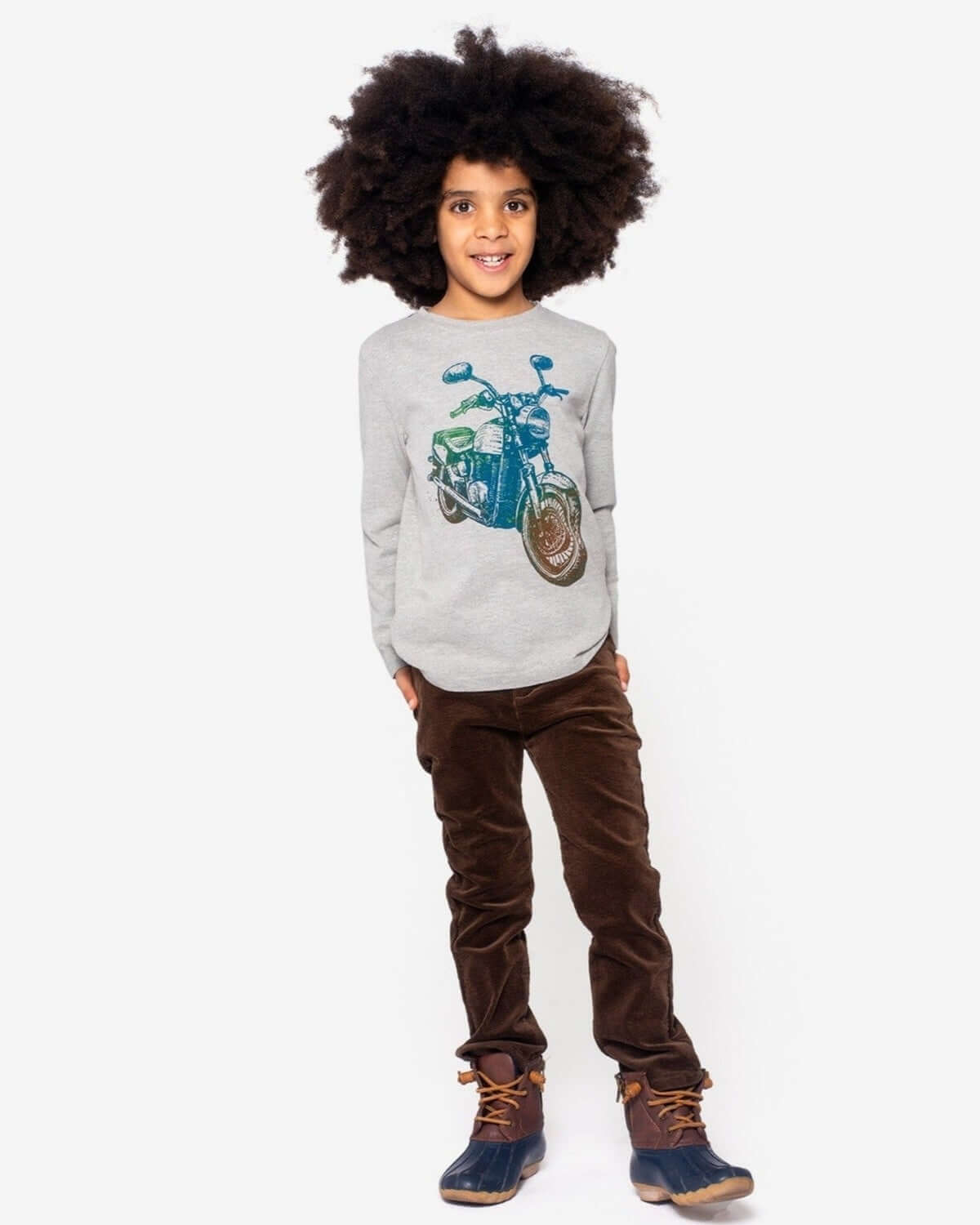 Stylish kid rocking brown skinny cords and a cool motorcycle tee—perfect for back to school adventures!