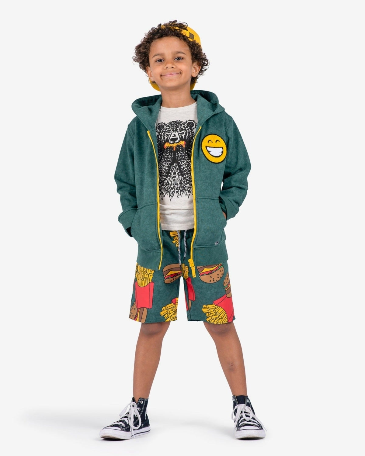 Stylish kid rocking Appaman's Burgers & Fries Camp Shorts with a hoodie and tee, perfect for fun summer days!