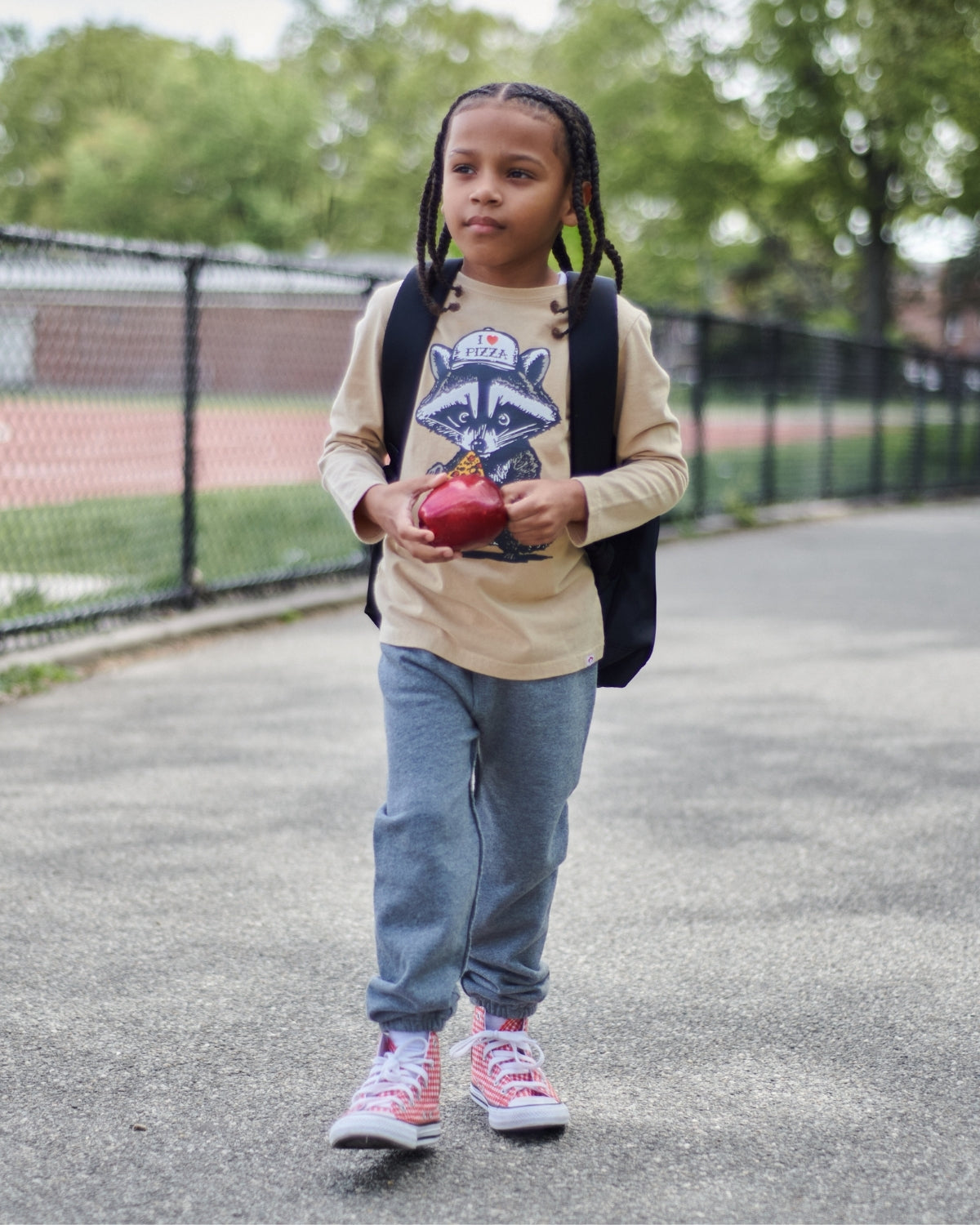 Cool kid in slippery-soft grey sweatpants, ready for school adventures with a stylish tee and backpack!