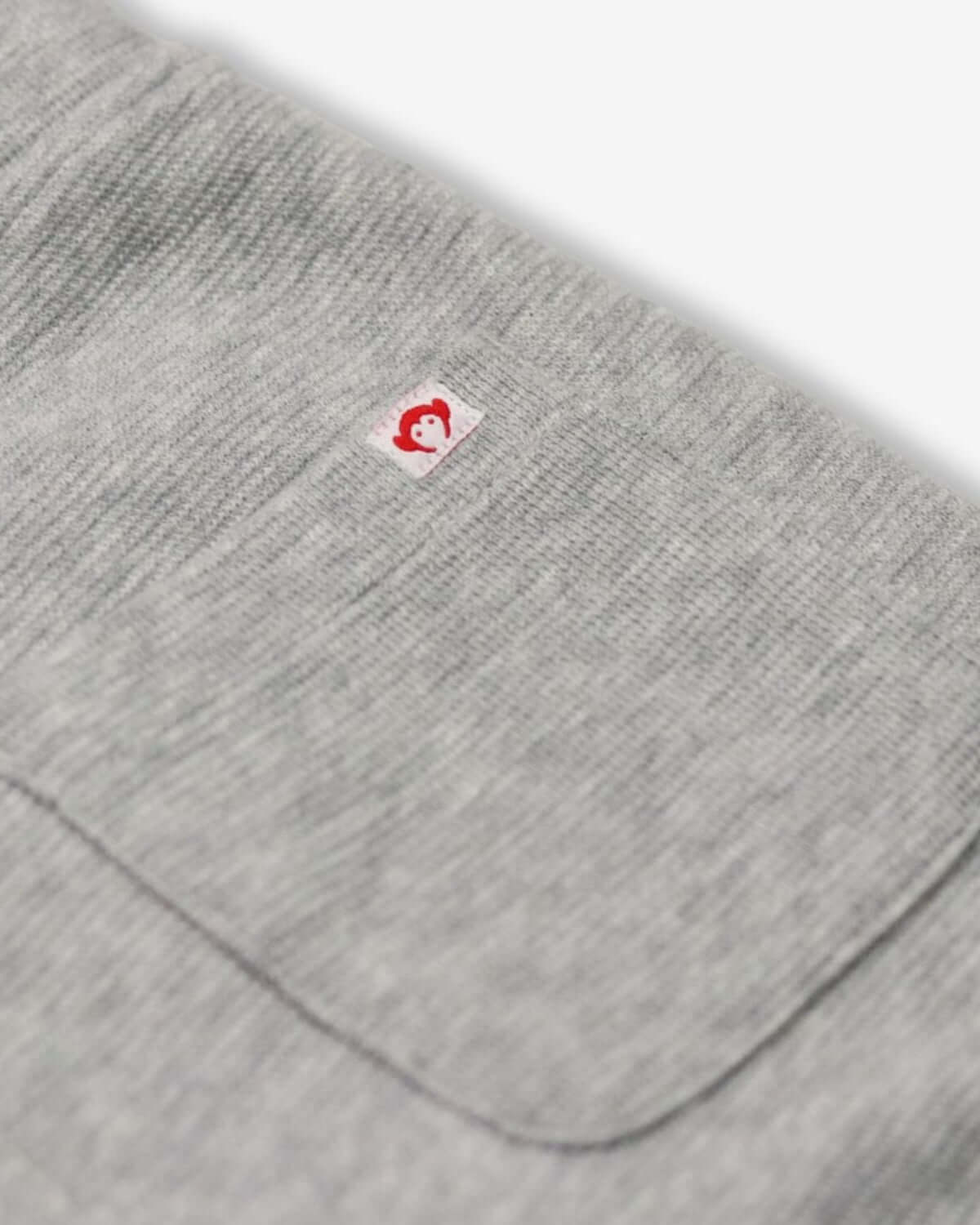 Close-up of heather mist fabric on Preston shorts, showcasing quality with playful signature logo—style for active kids!