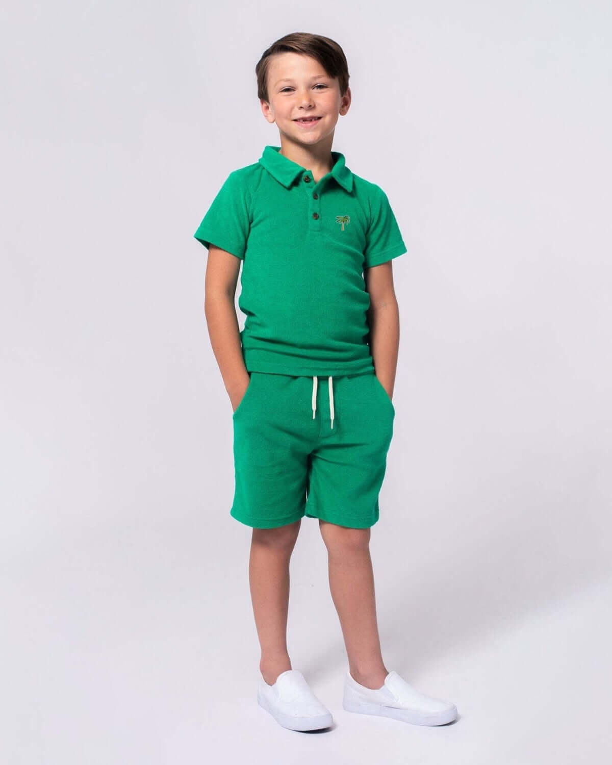 Boy wearing Kelly Green Preston Shorts and matching polo, perfect for summer adventures.