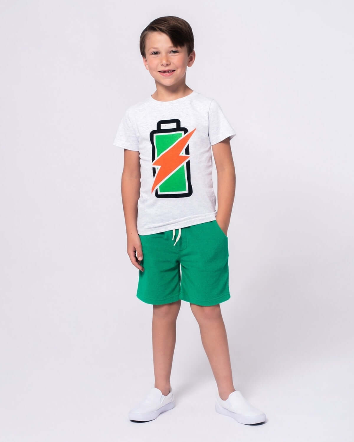 Boy wearing Kelly Green Preston Shorts and a battery graphic t-shirt, perfect for summer activities.