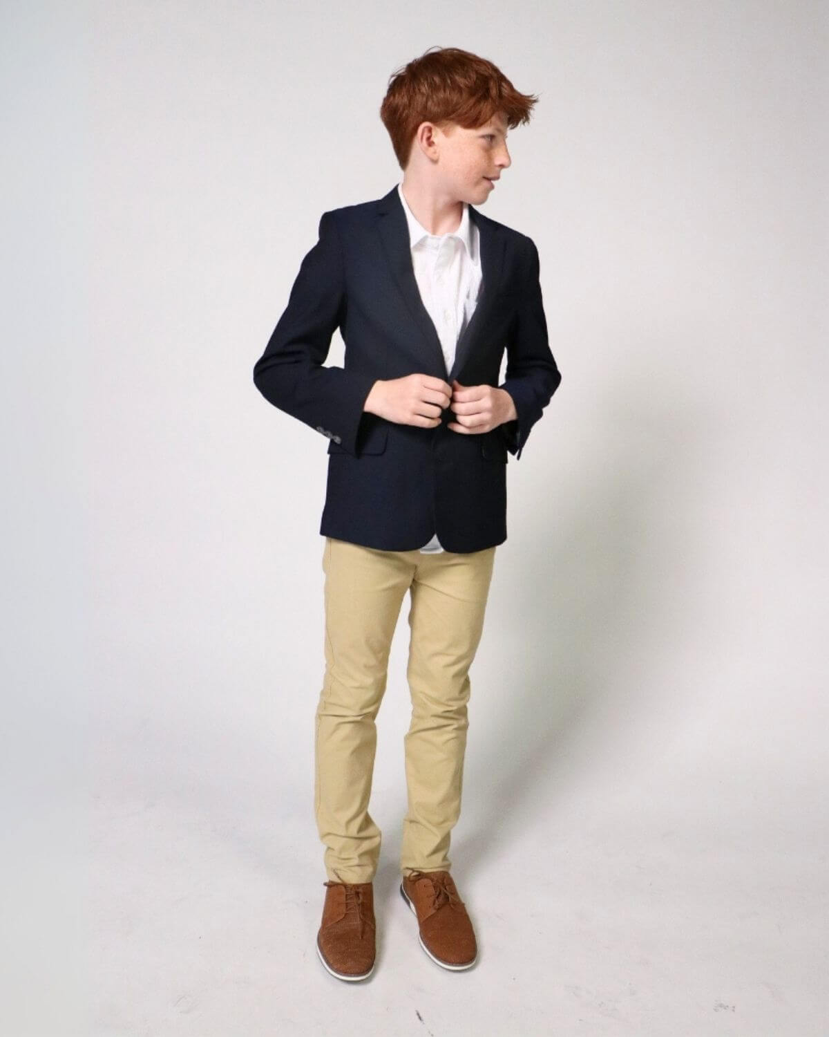 Stylish boy in a navy blazer and khaki twill pants, perfect for school events and family outings, blending fun and fashion!