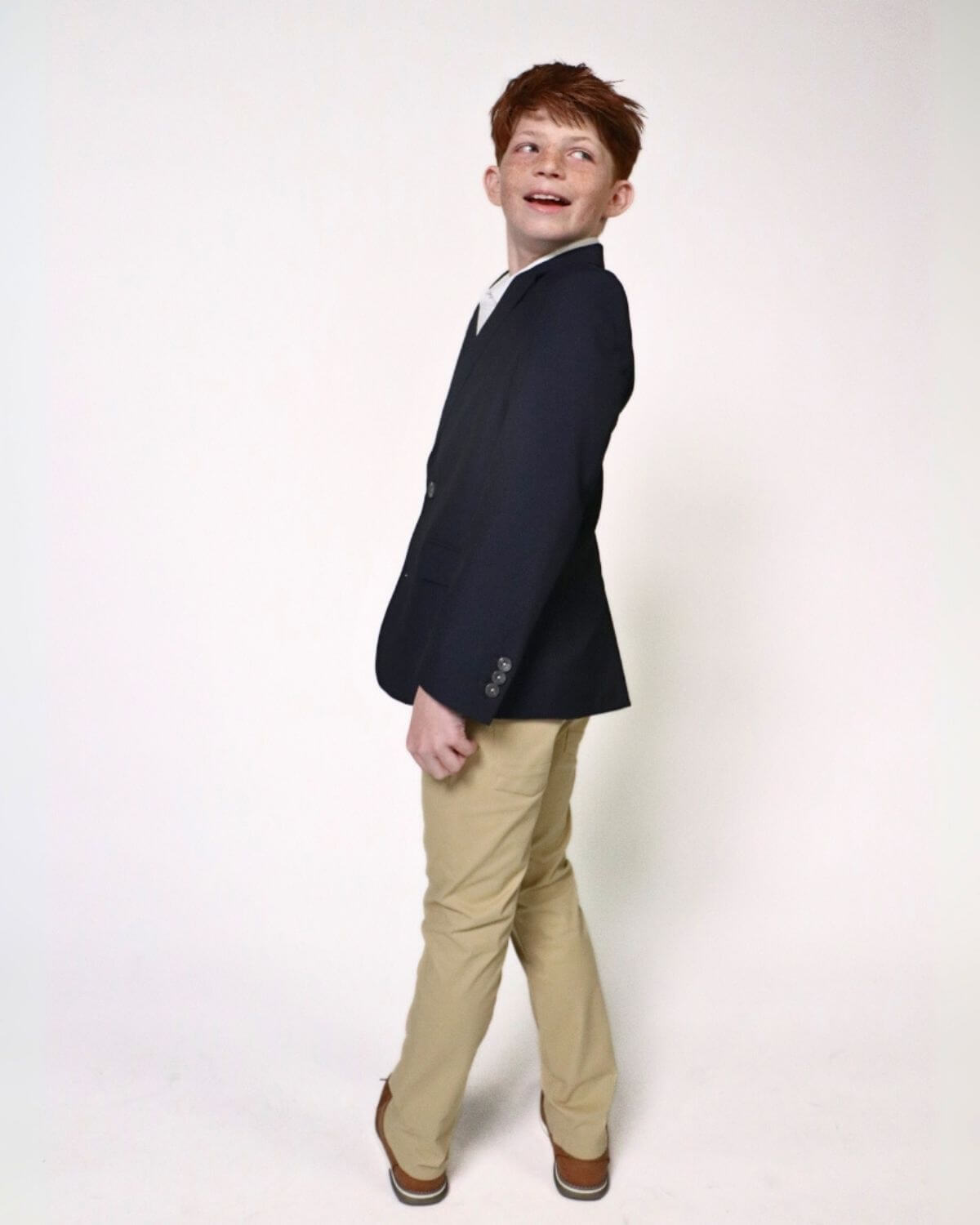 Stylish boy in a navy blazer and light khaki pants, ready for school or special events—classy comfort meets playful flair!