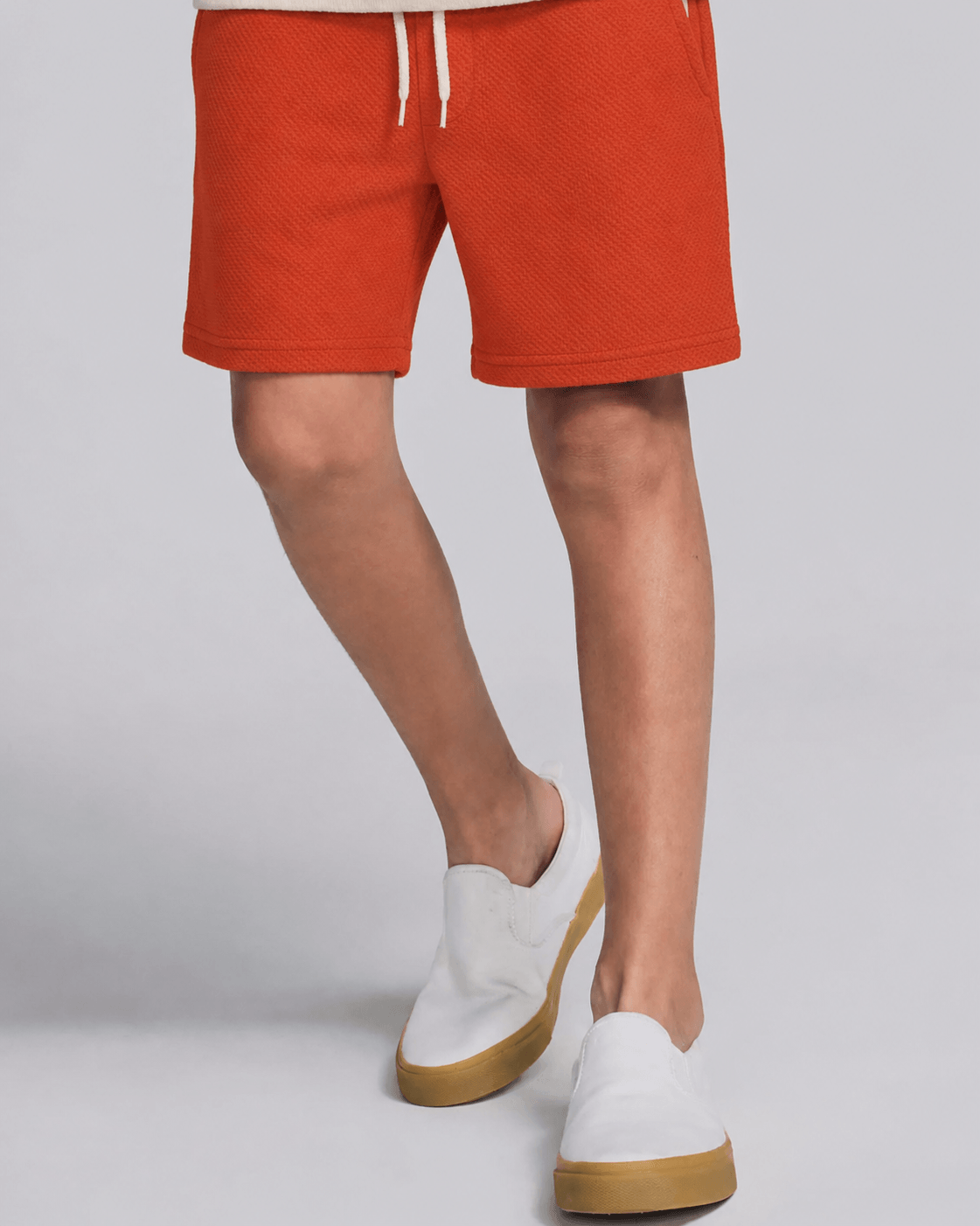 boy in red clay shorts