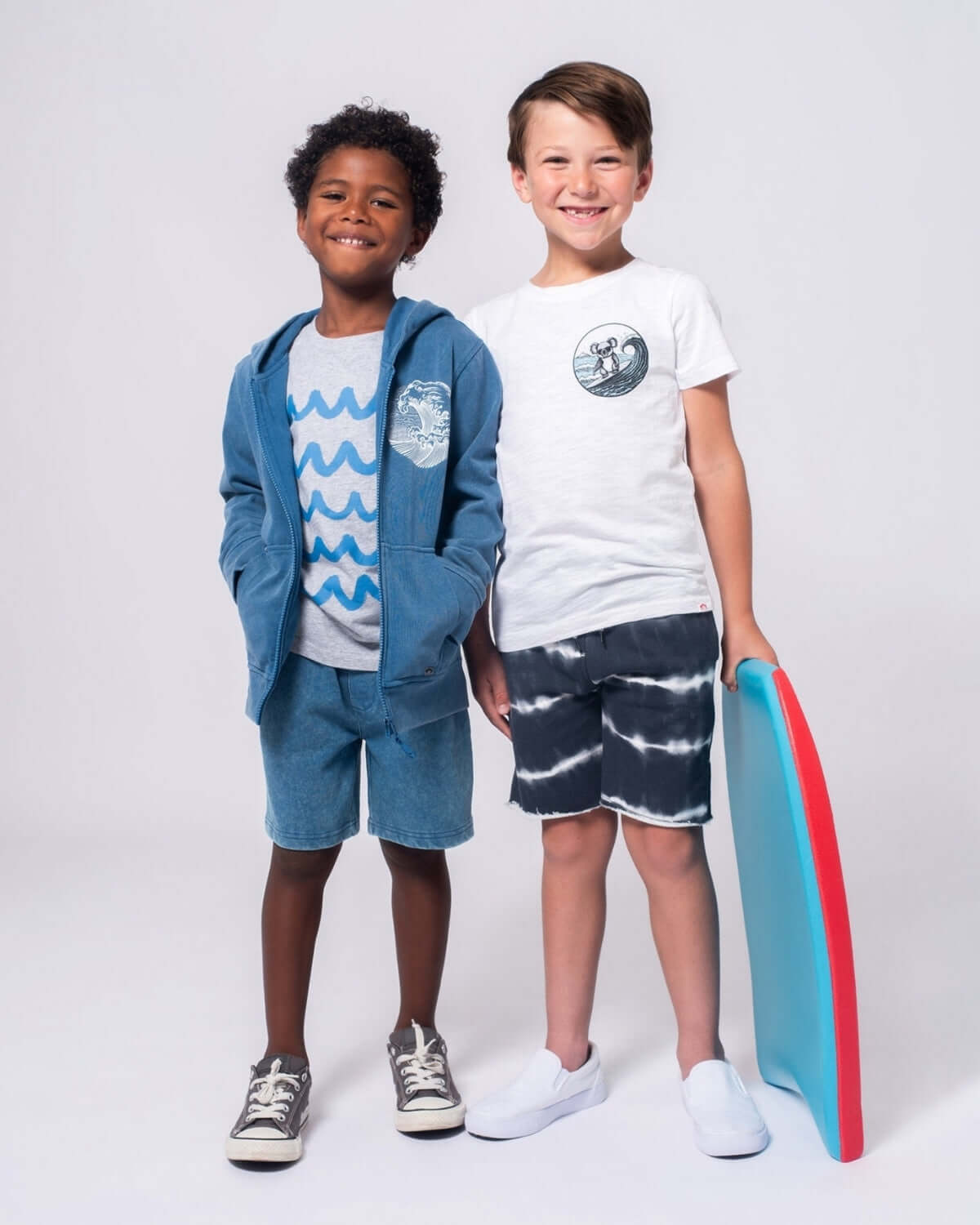 Two stylish boys rock summer vibes in Shadow Stripe Camp Shorts and cozy hoodies—perfect for beach adventures and back-to-school fun!