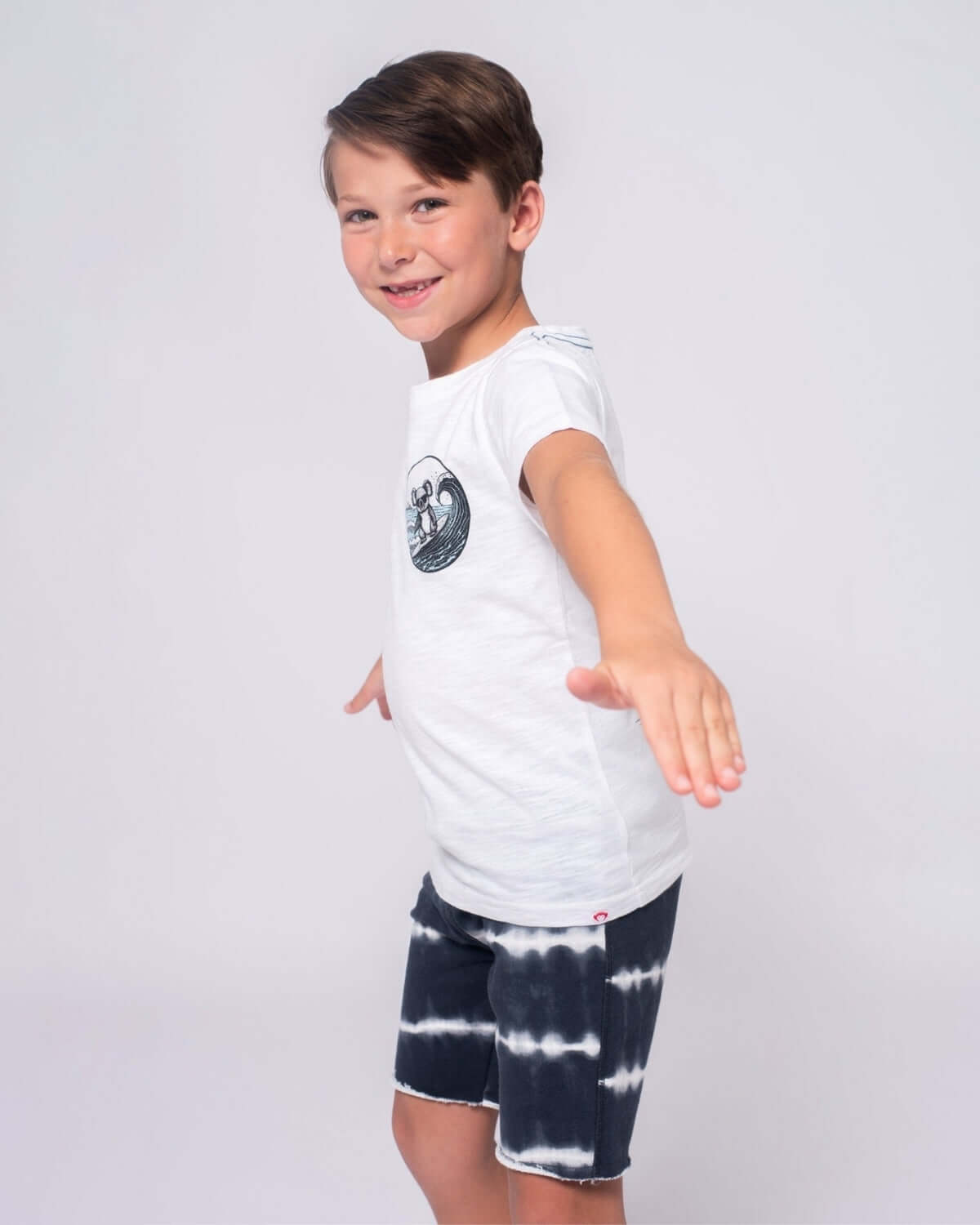 Stylish boy showing off his playful look in Shadow Stripe Camp Shorts, ready for summer adventures and playdates!