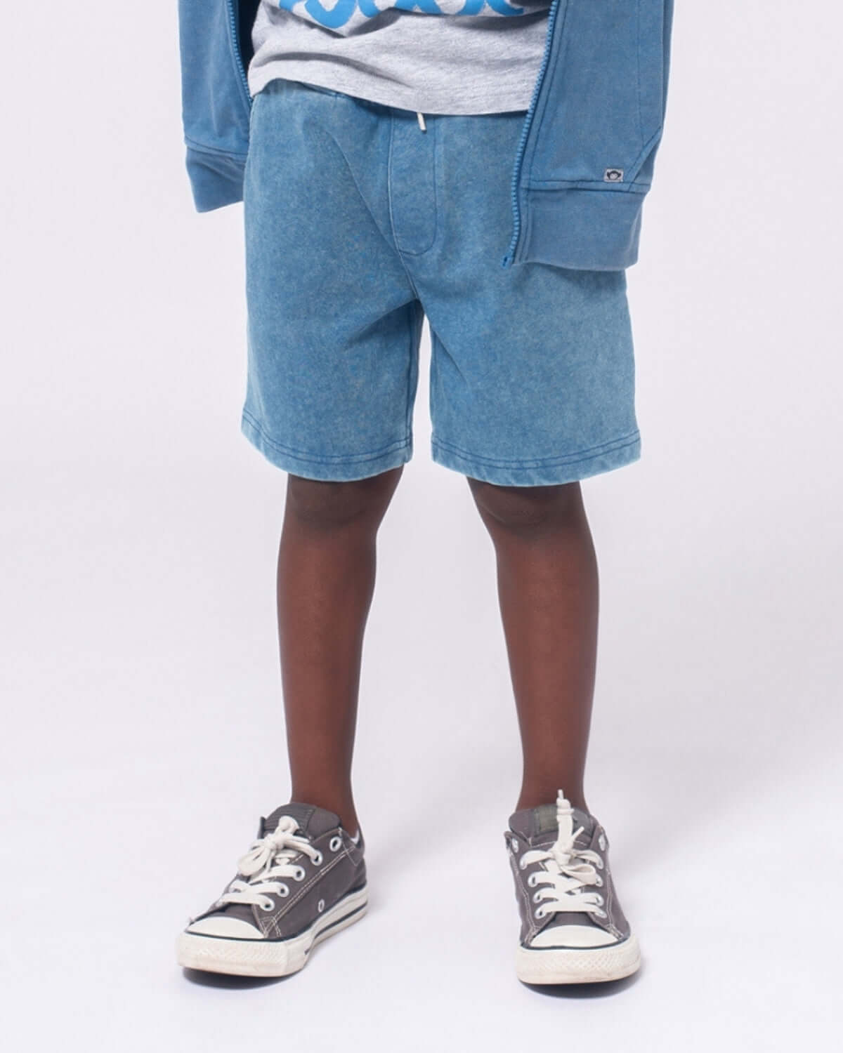 Sunwashed Blue Preston Shorts worn by a child paired with a gray hoodie and sneakers.