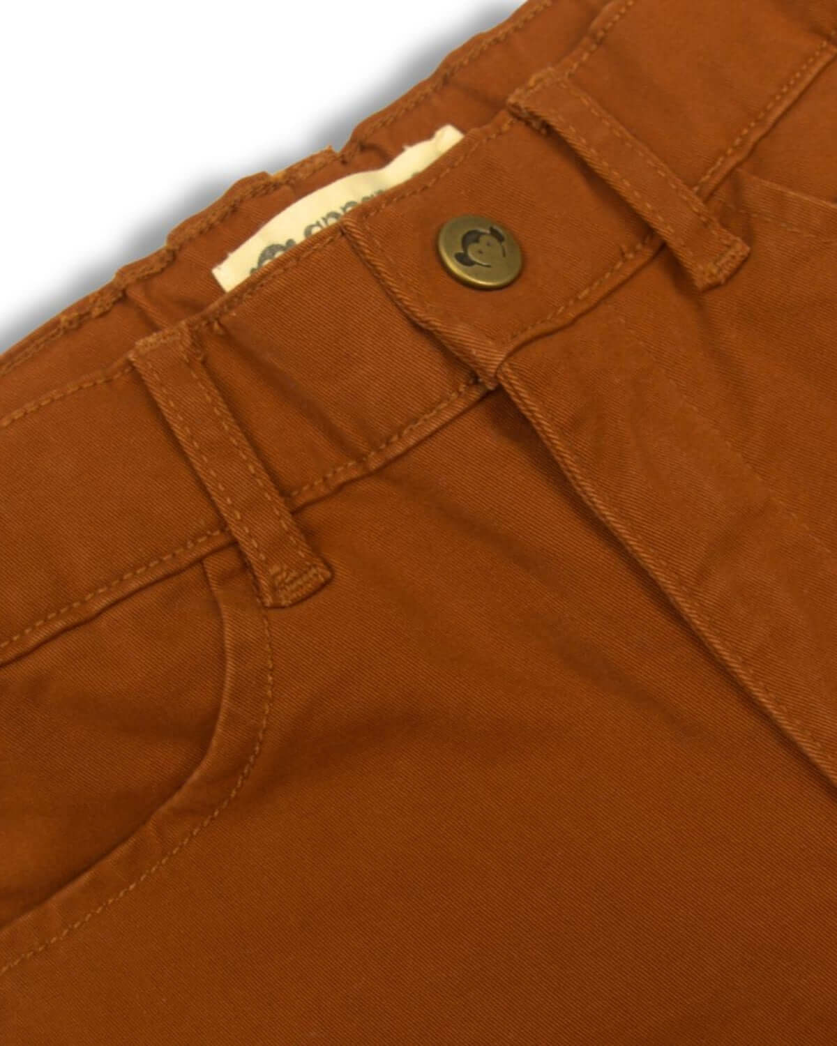 Close-up of Appaman's Terracotta Skinny Twill Pants, showcasing stylish craftsmanship and durable fabric for kids' back-to-school wardrobe.