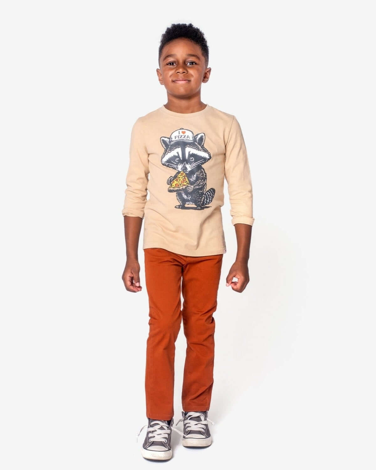 Boy wearing a graphic raccoon t-shirt and Terracotta Skinny Twill Pants, showcasing a stylish yet comfortable casual look.