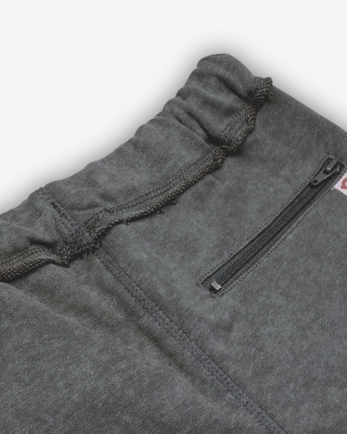 Close-up of Appaman's Vintage Black Brighton Shorts showcasing the comfy waistband and secure zip pocket.