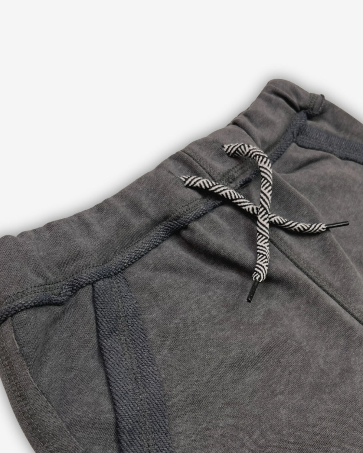 Close-up of Appaman's Vintage Black Brighton Shorts showcasing drawstrings and cozy fabric for stylish kids clothes.