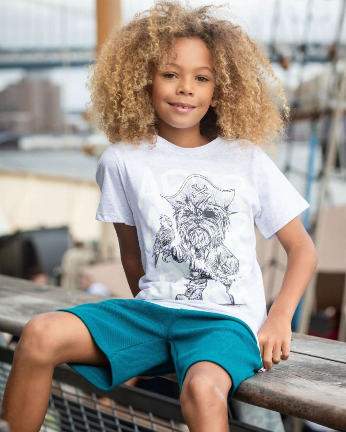 Boy wearing Captain York Graphic Tee with a playful pirate dog design, showcasing fun and adventure.
