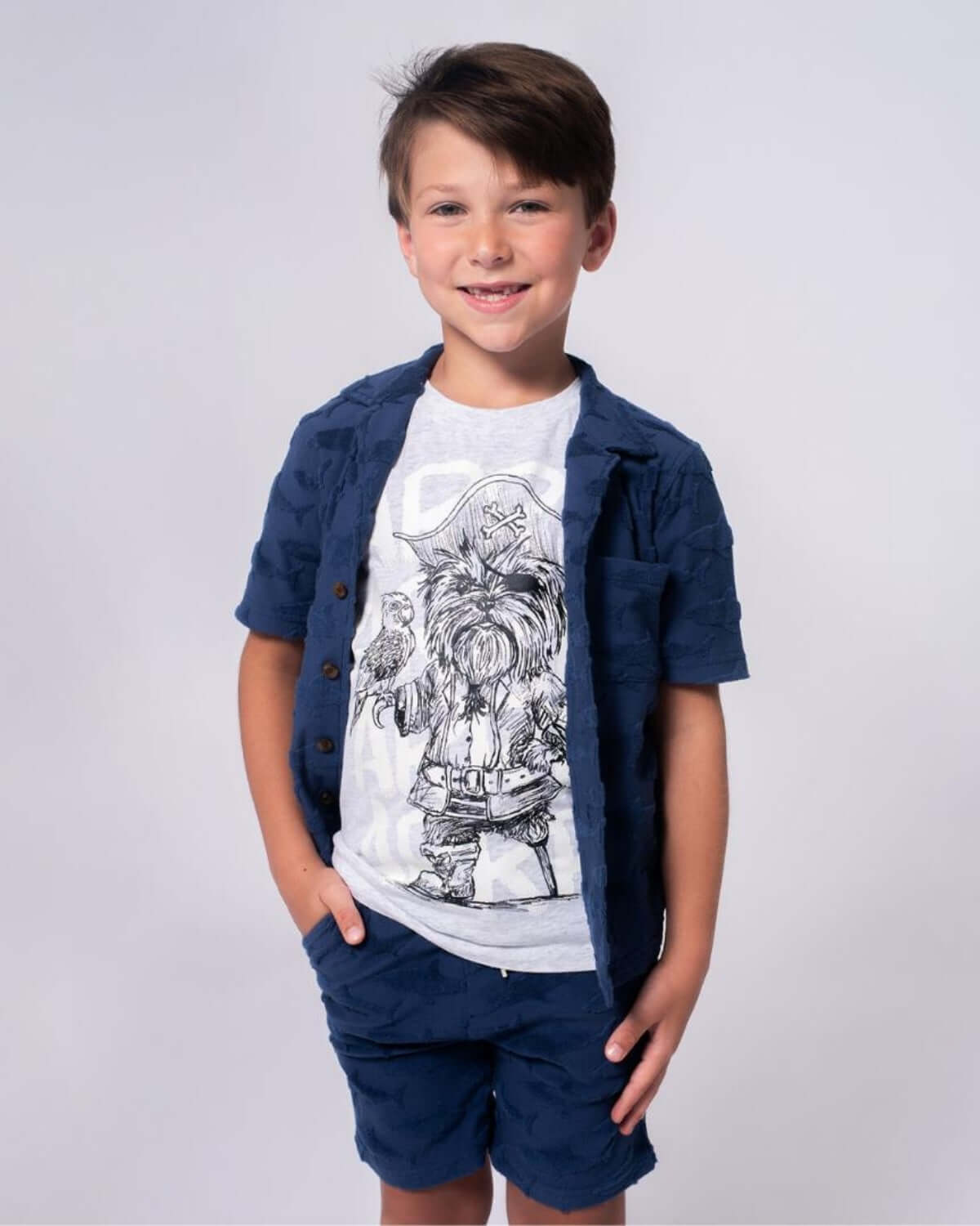 Captain York Graphic Tee worn by a smiling boy, featuring a playful pirate dog graphic.