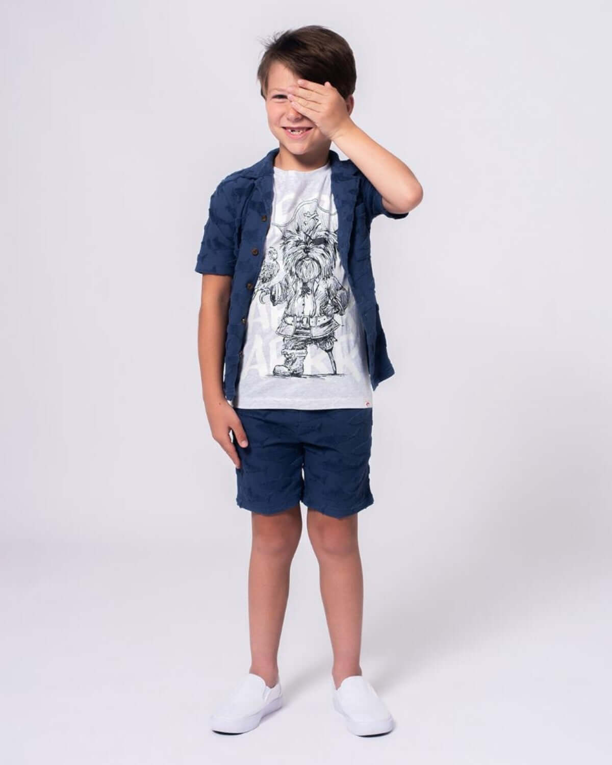 Boy wearing Captain York Graphic Tee with playful pirate design, styled for comfort and adventure.