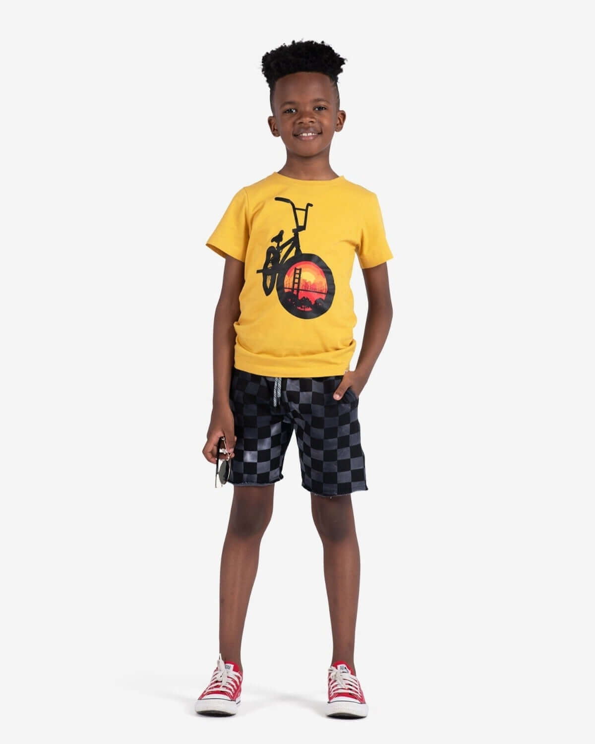 Kid wearing Goldenrod Graphic Tee with bike graphic and shorts, perfect for stylish casual outings.