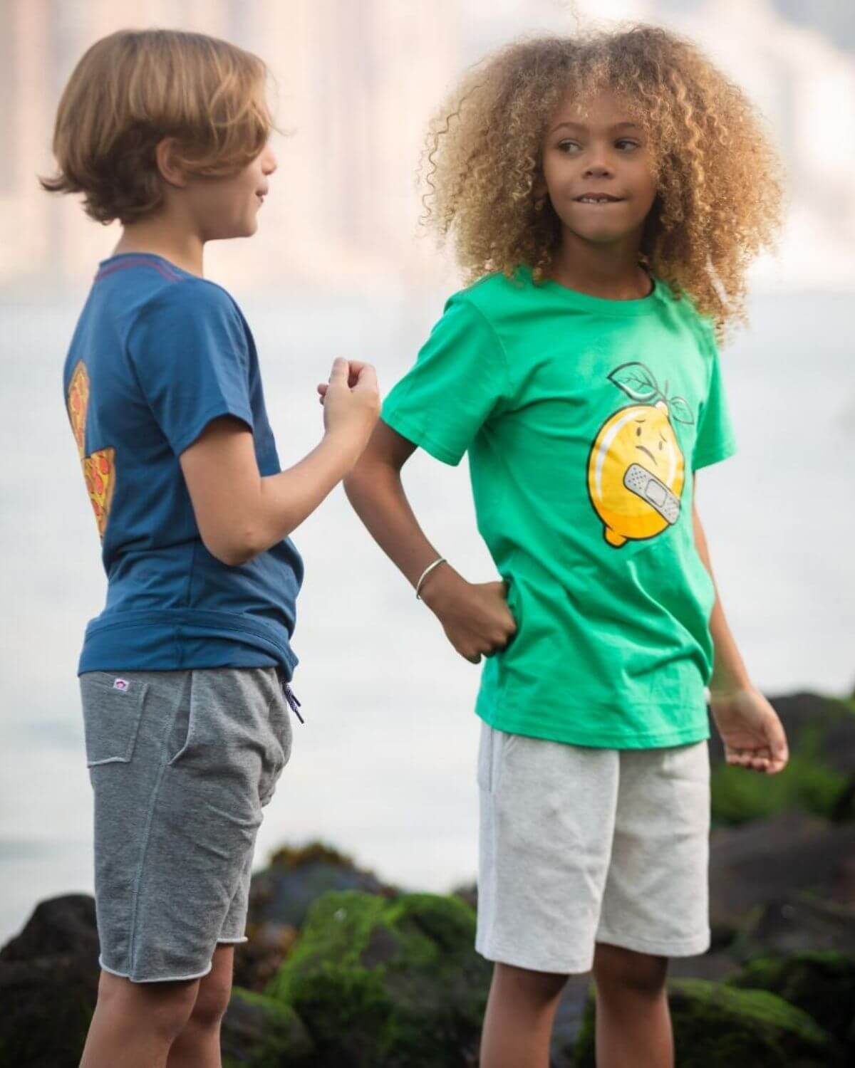 Kids enjoying a sunny day in playful Lemon Aid tees, highlighting bright colors and cheerful vibes for back to school fun!