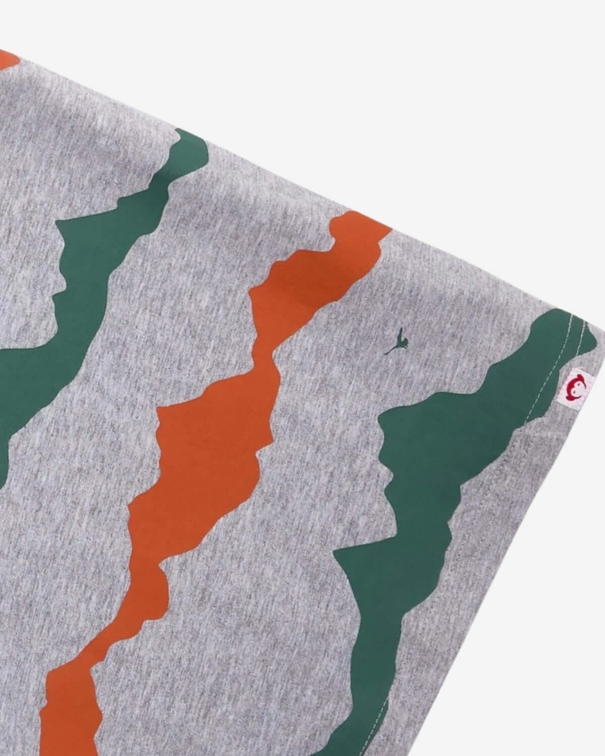 Mountain Peaks Graphic Tee showing bold green and orange designs on soft gray fabric for stylish kids' adventures.