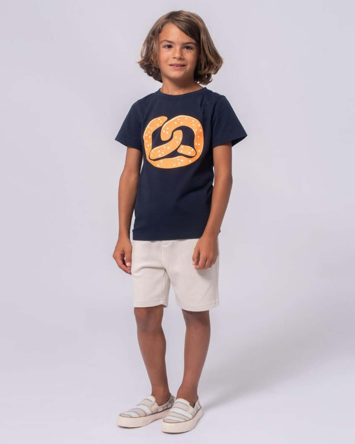 Boy in navy Pretzel Graphic Tee and shorts, showcasing comfy kids clothes—ideal for school or playtime adventures!