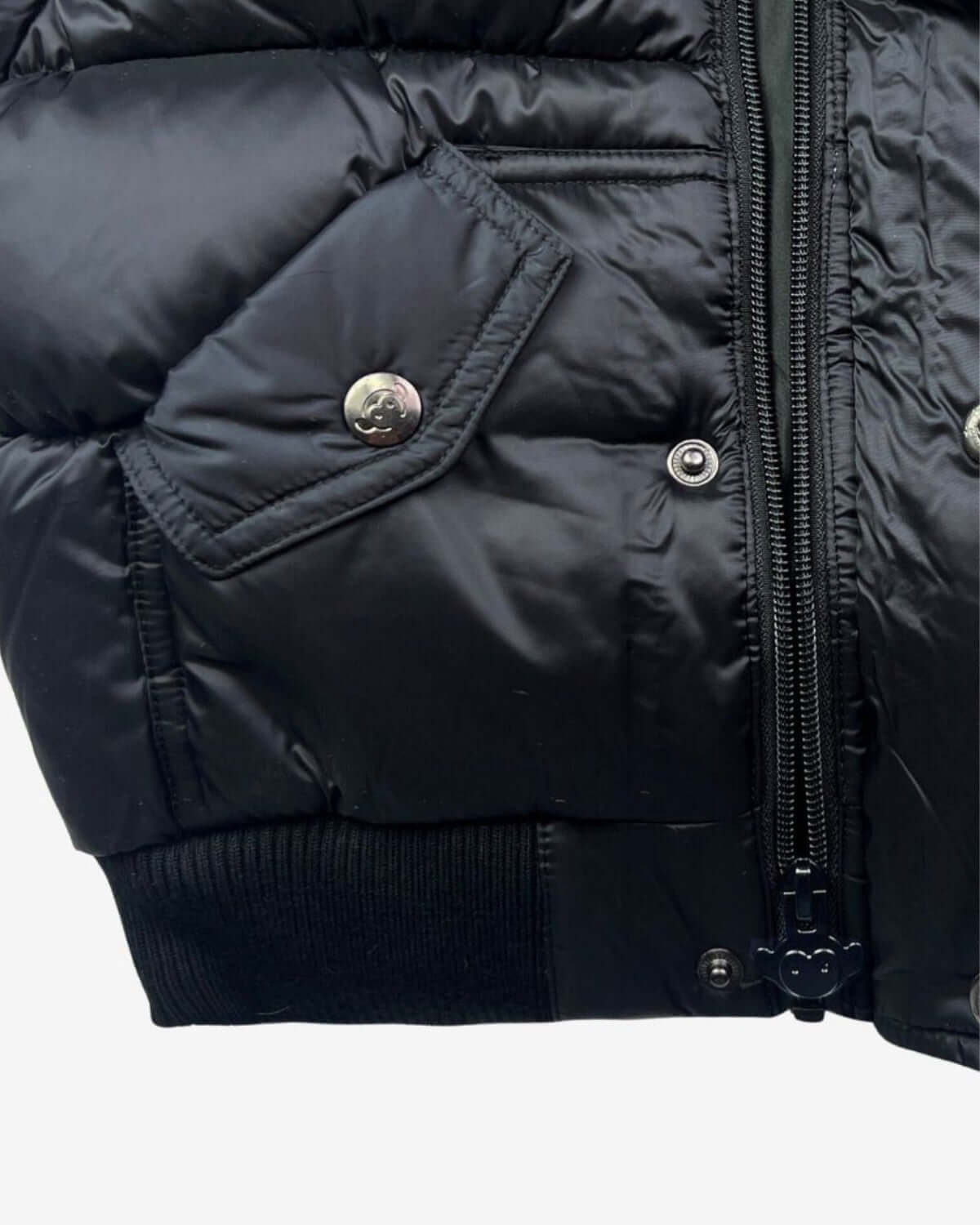 Close-up of the Kids Black Puffy Coat showcasing durable fabric, stylish zip, and trendy bomber fit for boys' winter fashion.