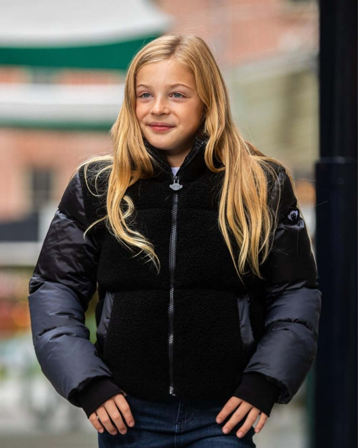 Stylish girl in a cozy black cropped puffer jacket, perfect for chic winter adventures and back-to-school vibes!