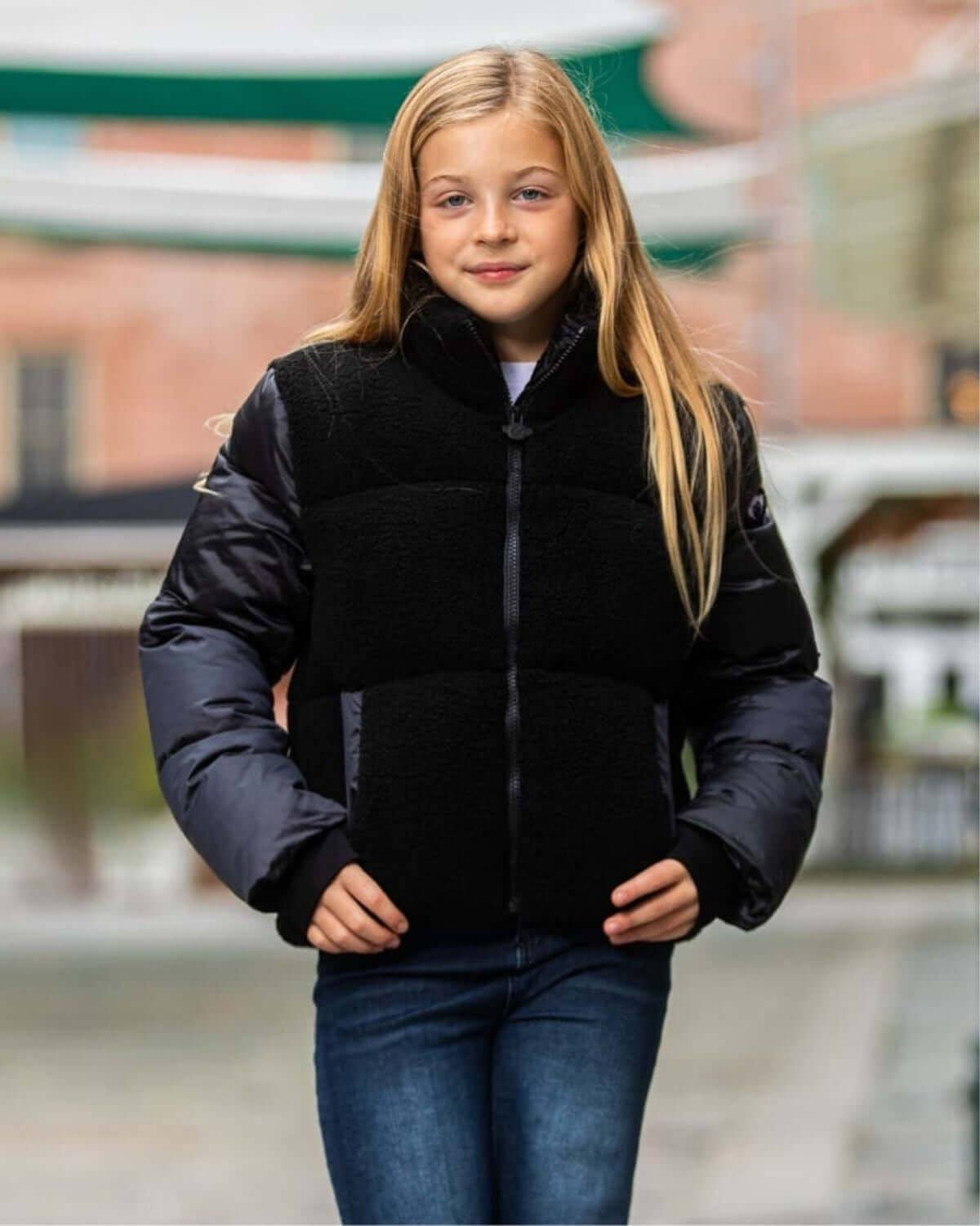 Stylish kid in a cozy Black Teddy Cropped Puffer jacket, blending comfort and chic for back-to-school adventures!