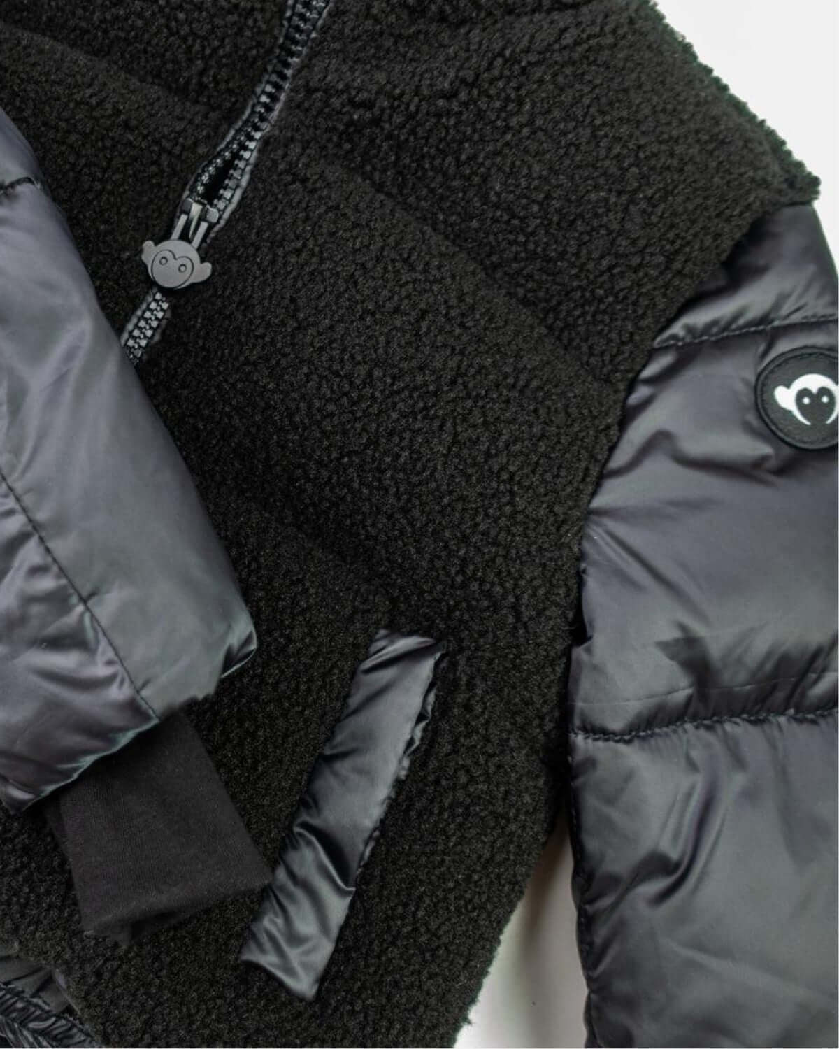Cozy black teddy cropped puffer jacket featuring luxe faux fur for stylish kids' winter wear.