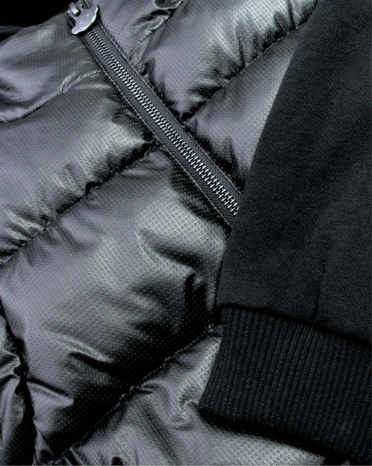 Close-up of the stylish Black Turnstile Jacket showcasing its luxurious puffer texture and snug cuffs—a must-have for kids this fall!