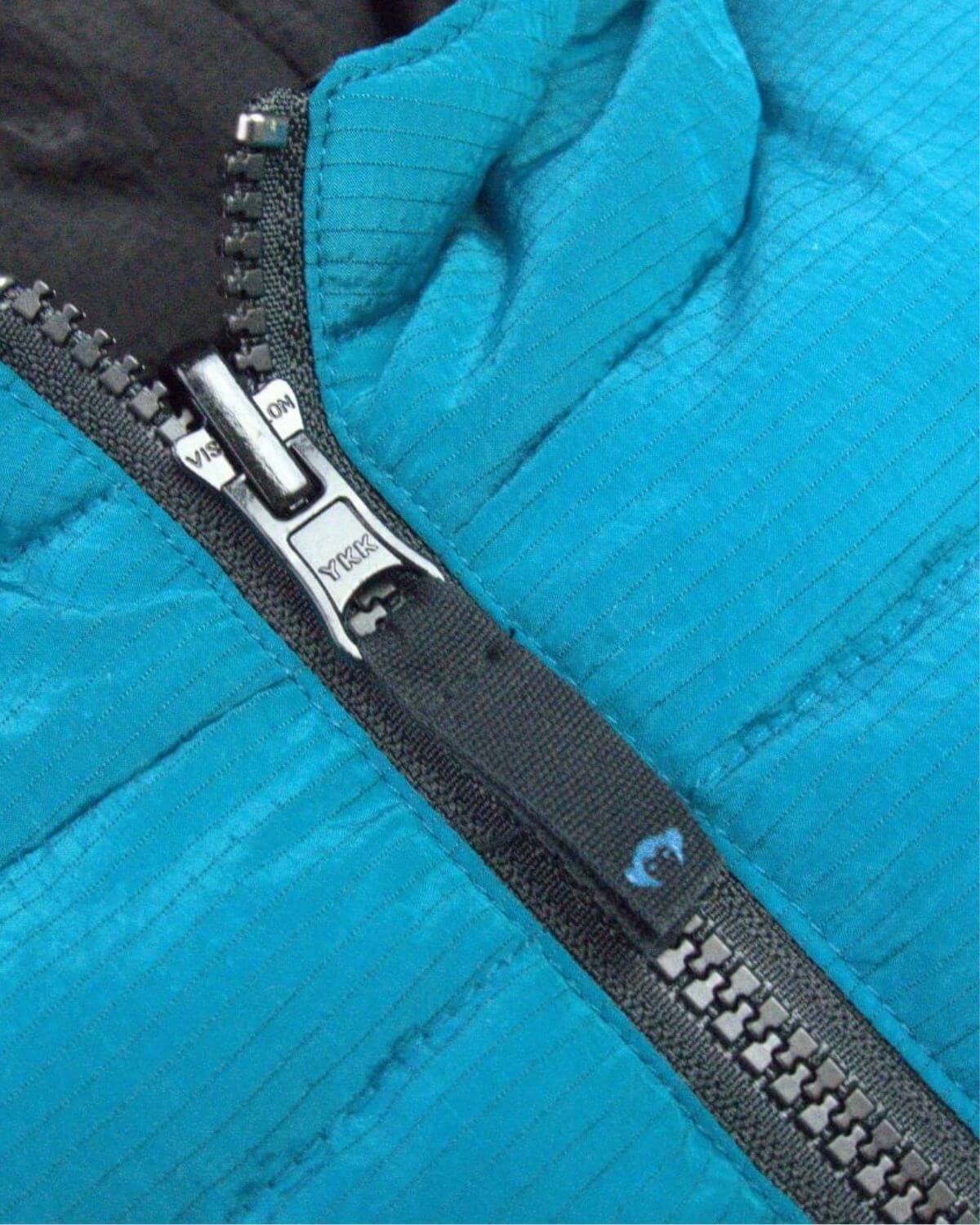 Close-up of the vibrant Blue Jewel reversible vest zipper, showcasing quality craftsmanship for stylish kids' clothes.
