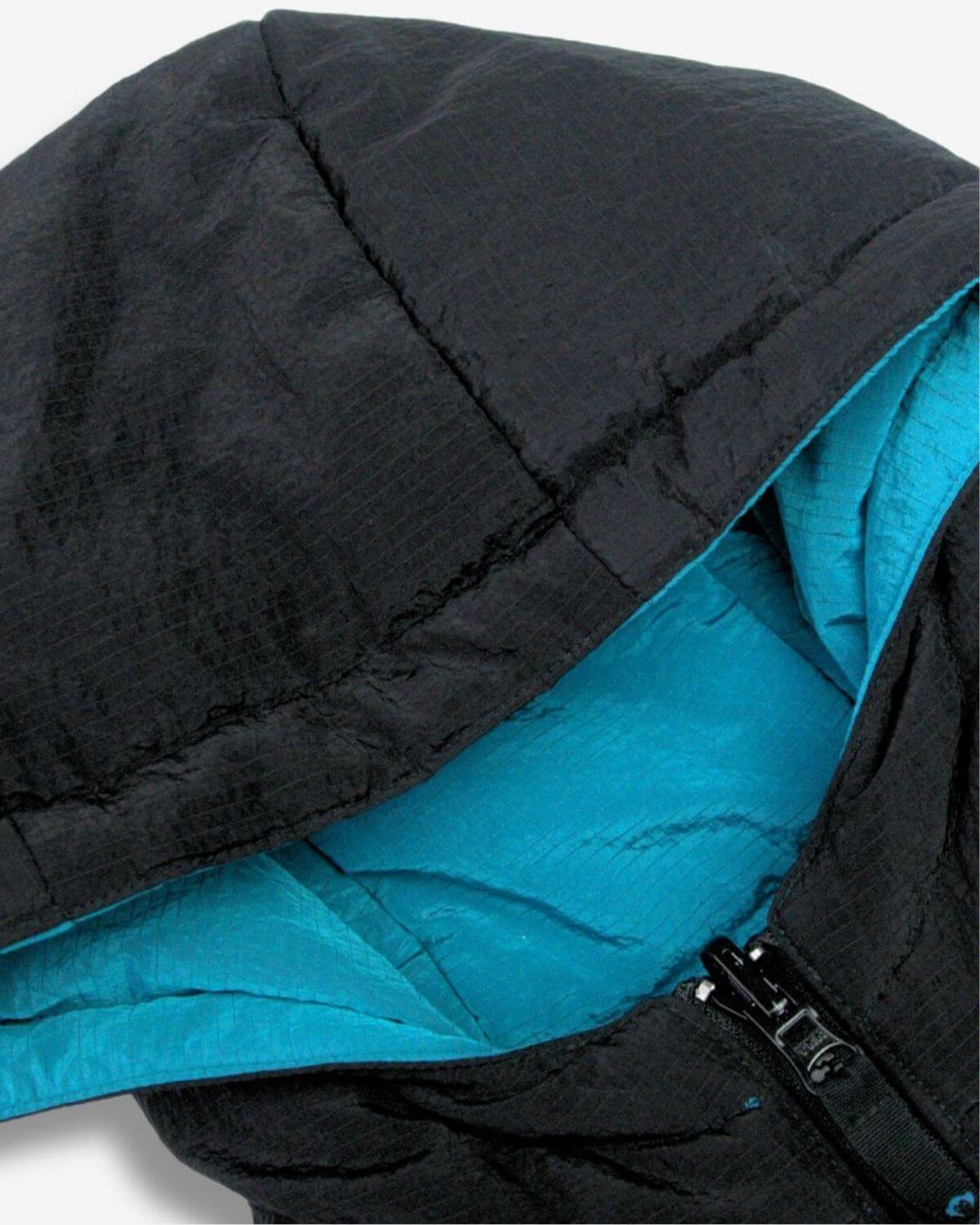 Cozy bubble hood of Appaman's Blue Jewel reversible vest, featuring vibrant teal lining and sleek black exterior.