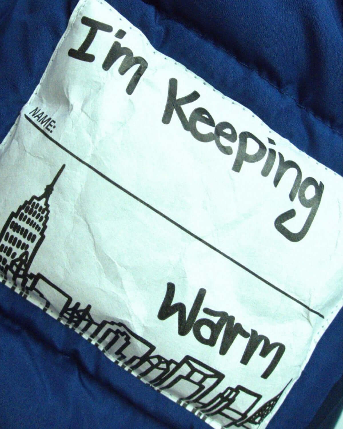 Fun label on Appaman's Classic Blue transit coat, ready to keep kids warm and stylish during winter adventures!