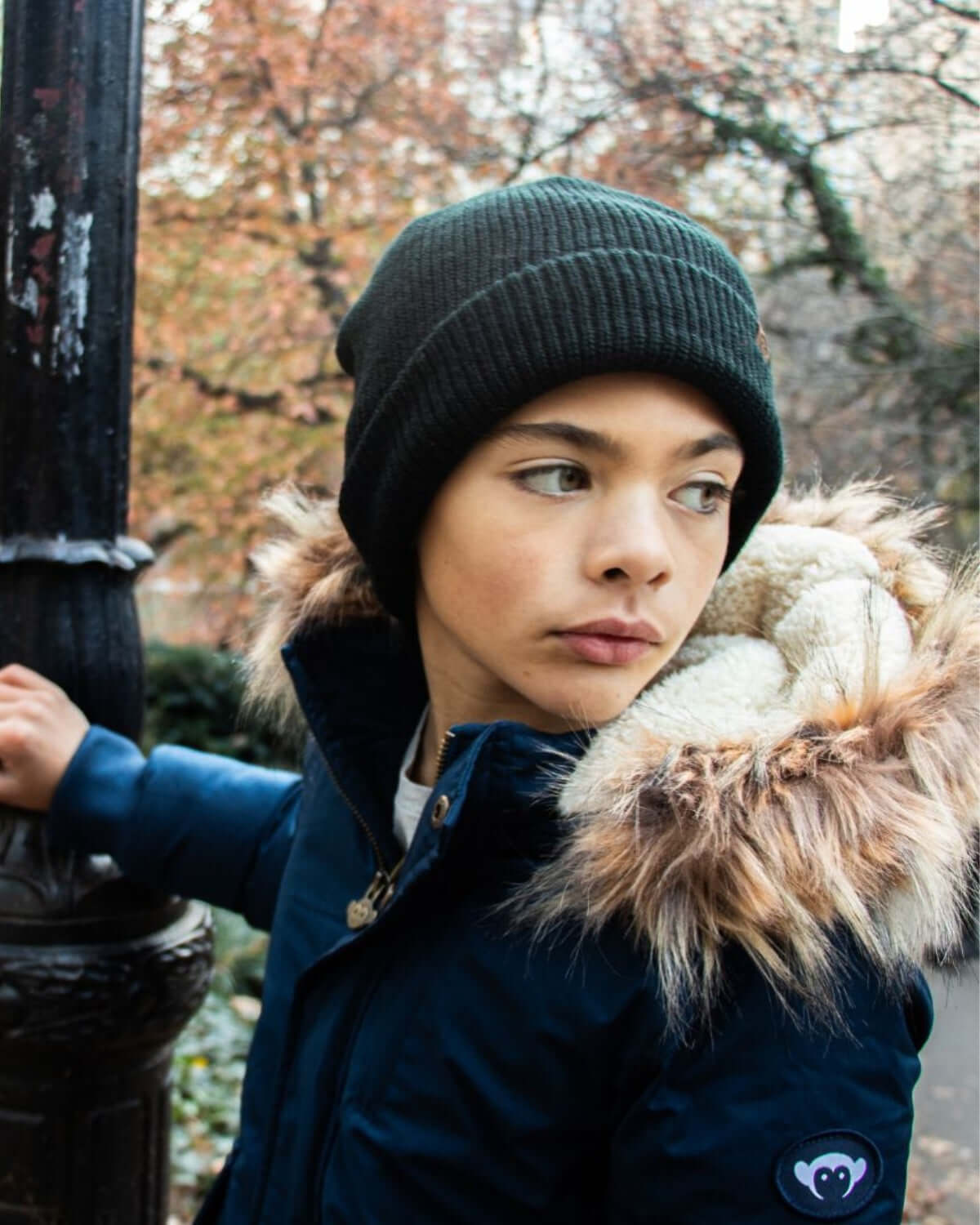 Stylish boy in a cozy blue City Transit Coat with faux fur, ready for winter adventures!