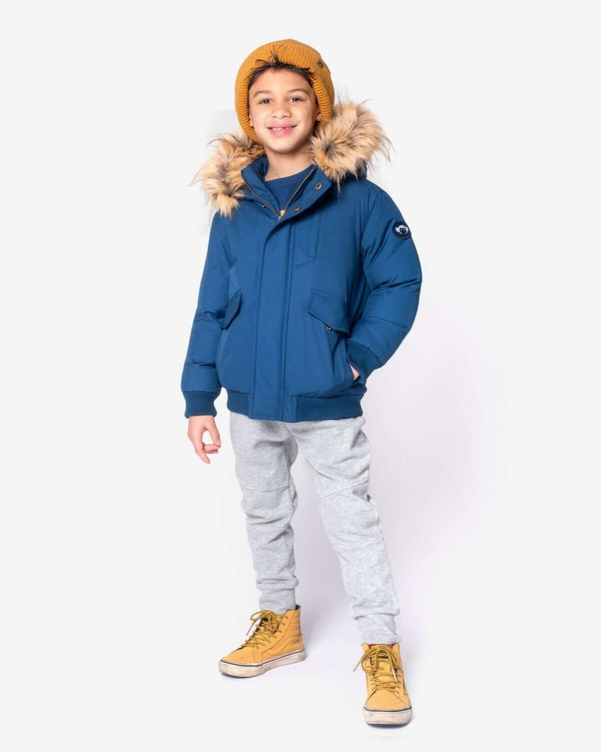 Stylish kid rocking the Classic Blue City Transit Coat with faux fur hood—perfect for winter adventures! #KidsClothes #BackToSchool