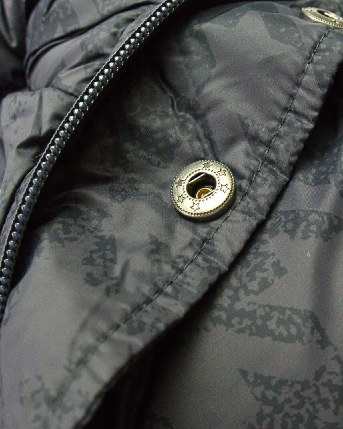 Close-up of the stylish zipper and buttons on the Houndstooth Puffy Coat, perfect for keeping kids warm in style.
