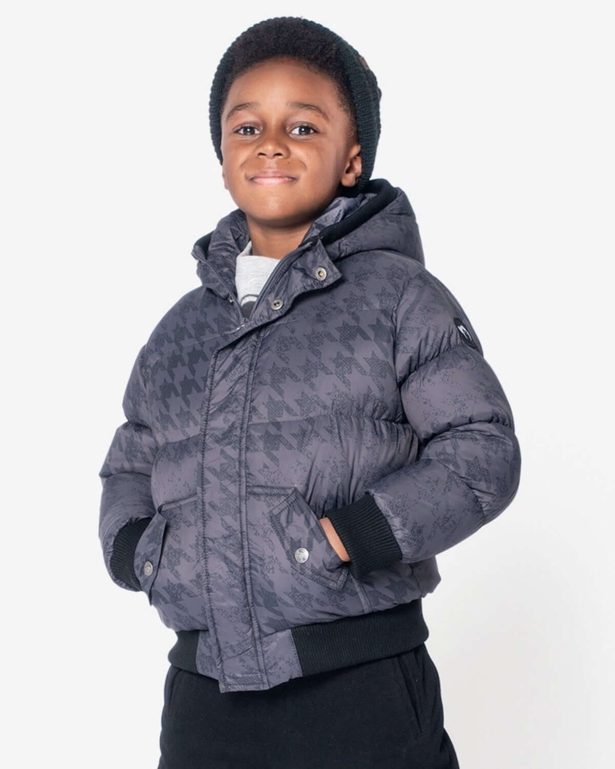 Stylish kid in a Houndstooth Puffy Coat, ready to conquer winter in high-quality, durable kids clothes.