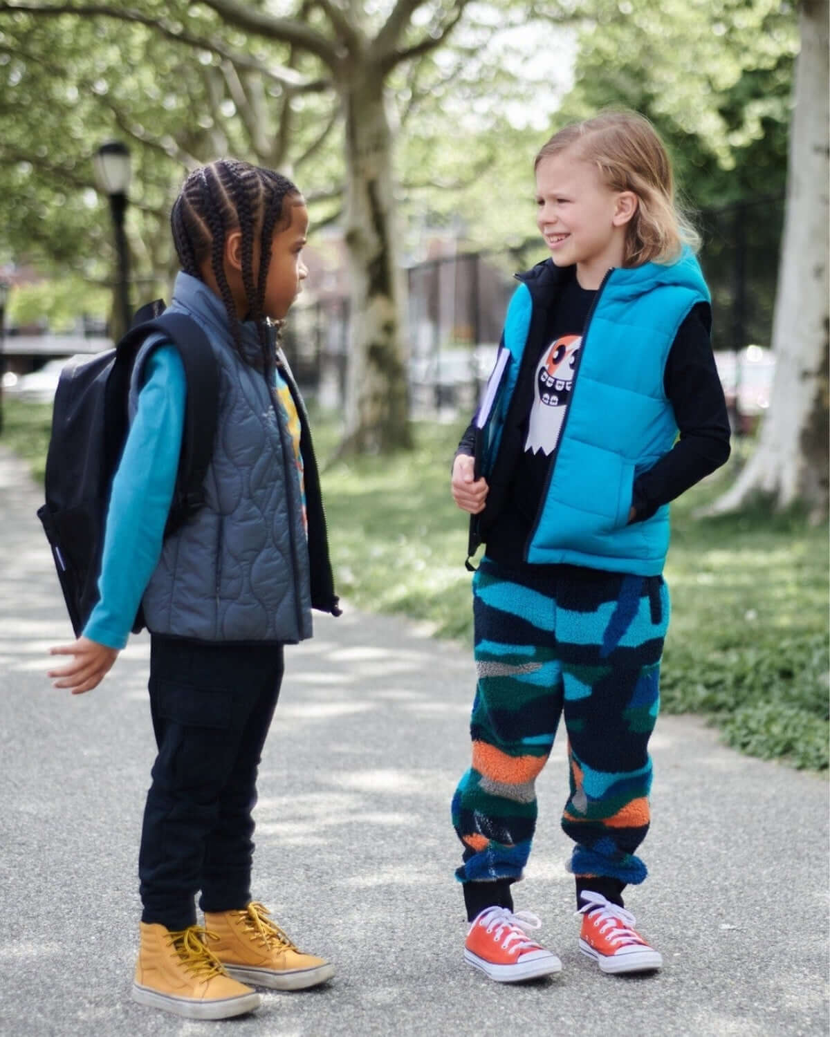 Two kids in stylish vests, showcasing playful outfits for back to school—modern boys' and girls' clothes with flair!