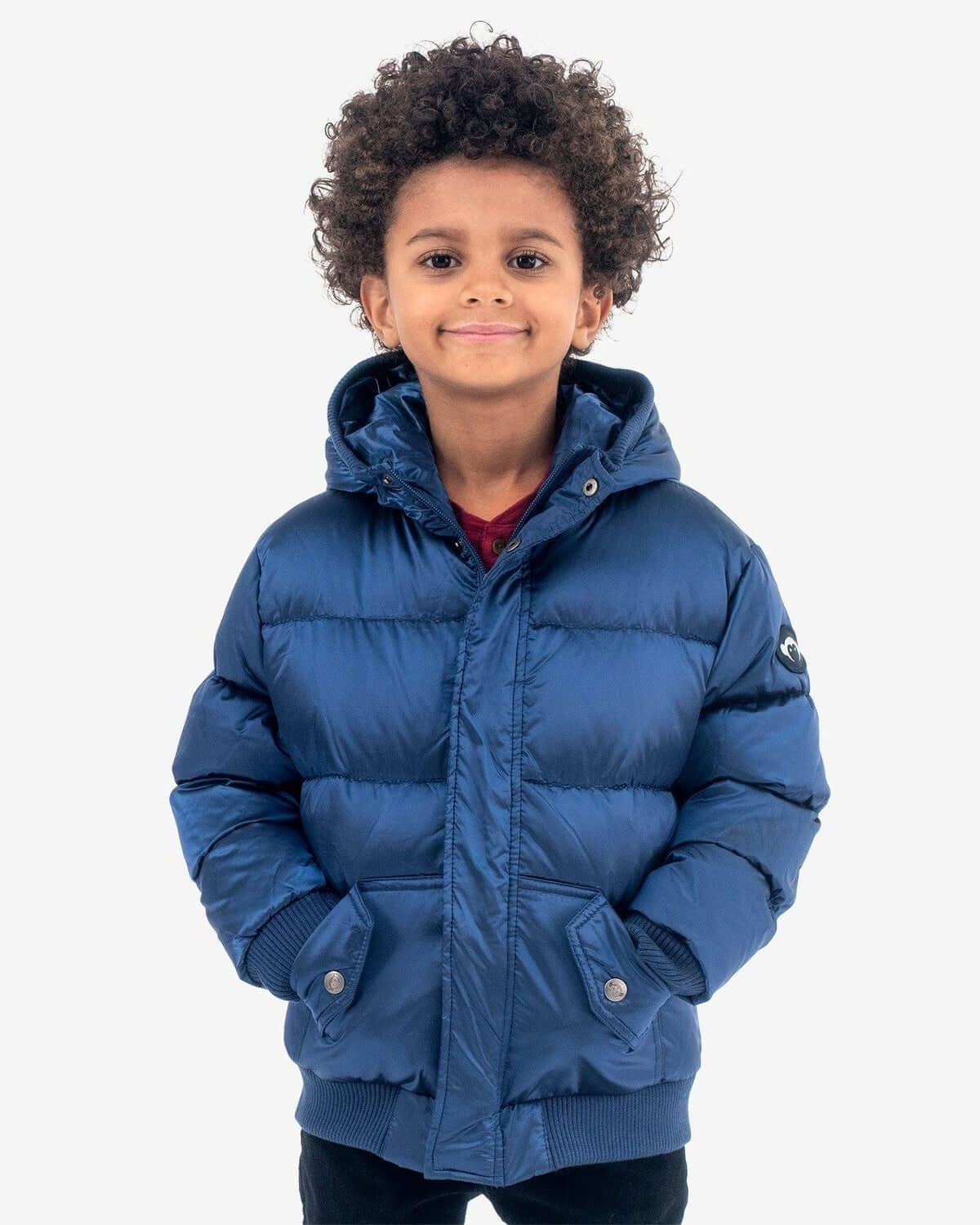 Stylish kid in a cozy navy blue puffy coat, ready for winter adventures in high-quality kids clothes.