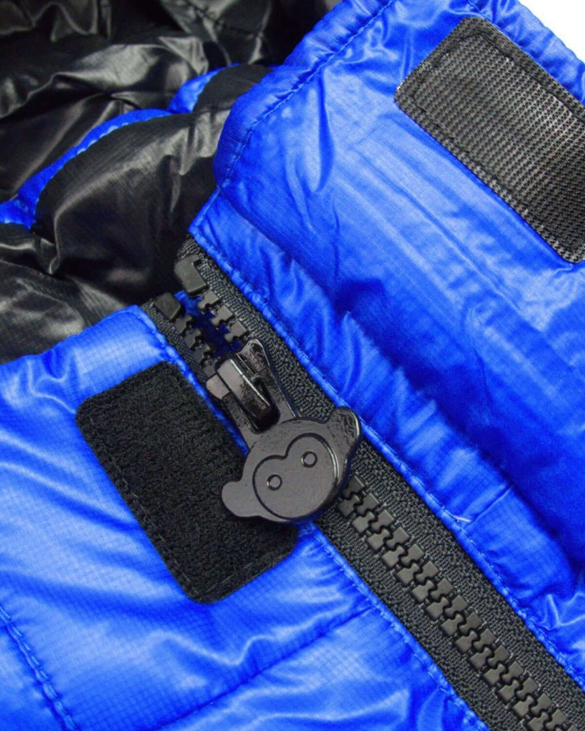 Close-up of the stylish Reflex Blue Summit Puffer Coat's zipper and fabric, showcasing its quality and durability for kids.