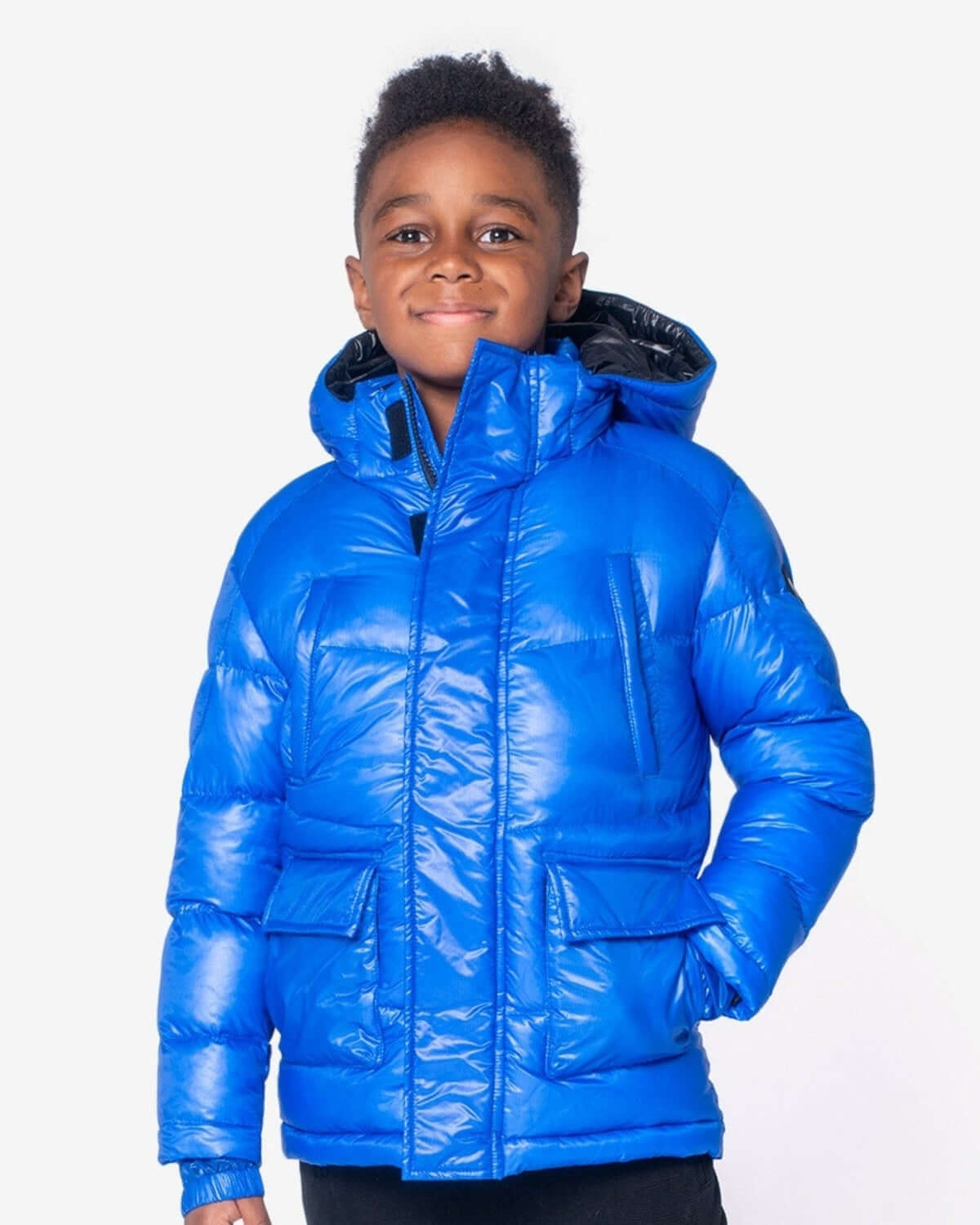 Stylish boy in a vibrant Reflex Blue Summit Puffer Coat, ready for winter fun and warmth in high-quality kids clothes!