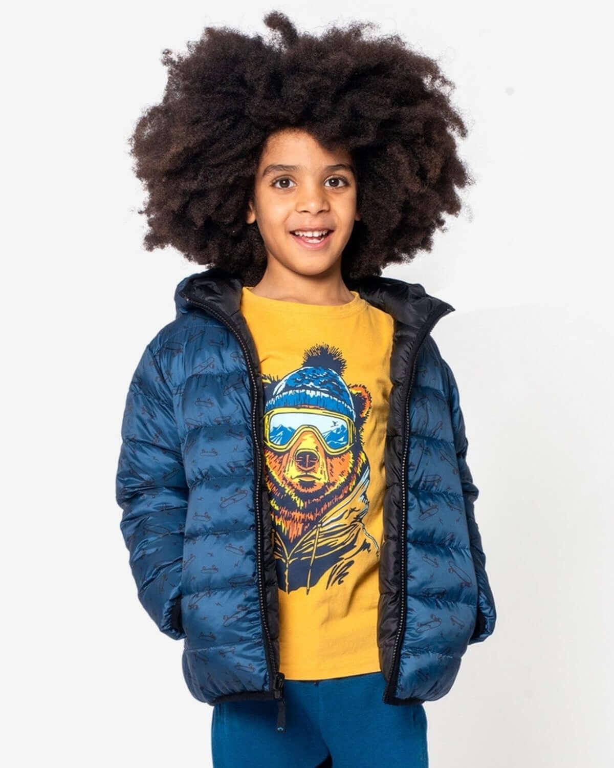 Cheerful kid rocking the Skater Vibes Reversible Puffer in Blue Wave, stylishly ready for class and winter fun!