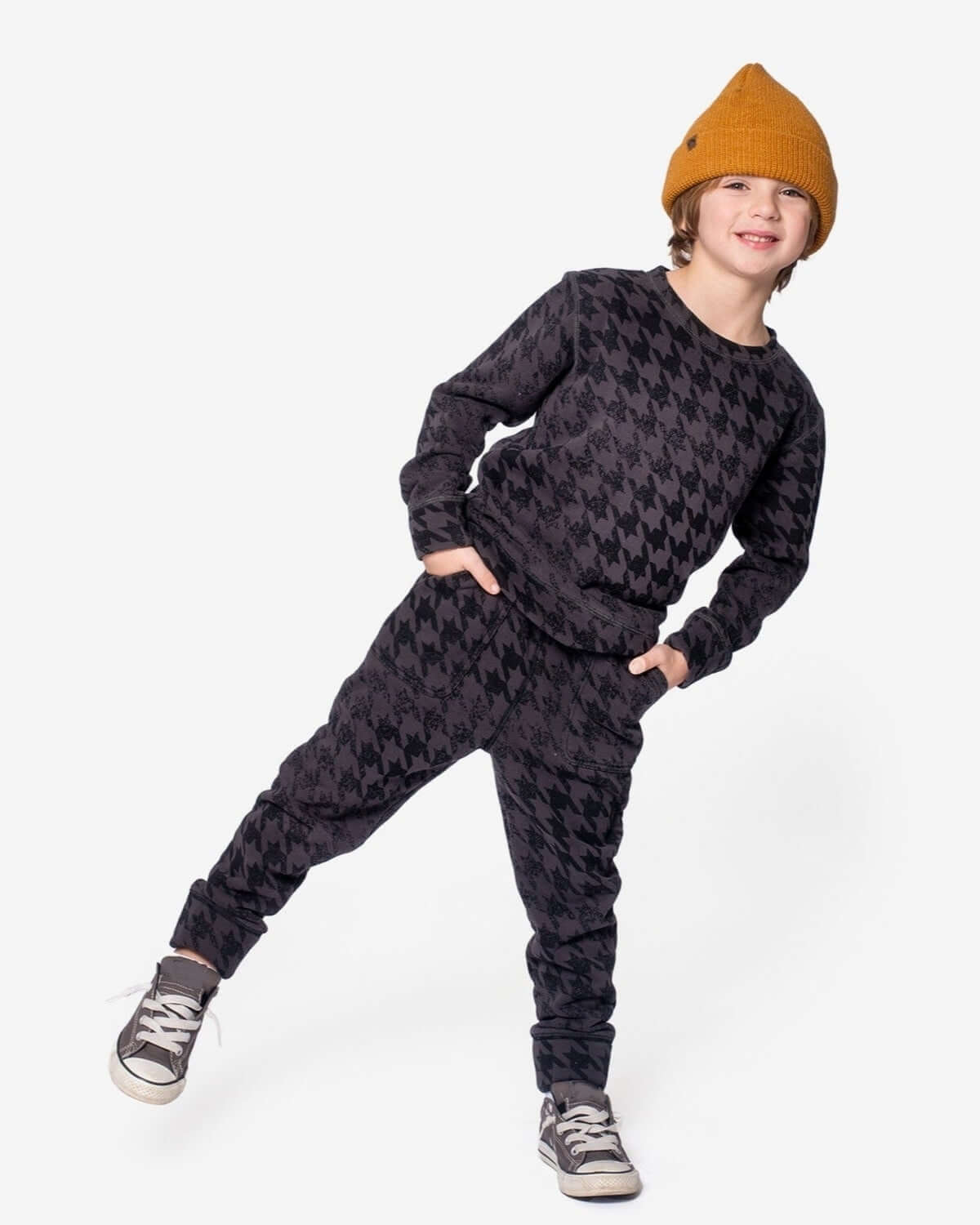 Stylish kid rocking the Black Houndstooth Revel Crewneck—fun, cozy, and oh-so-durable for back to school adventures!
