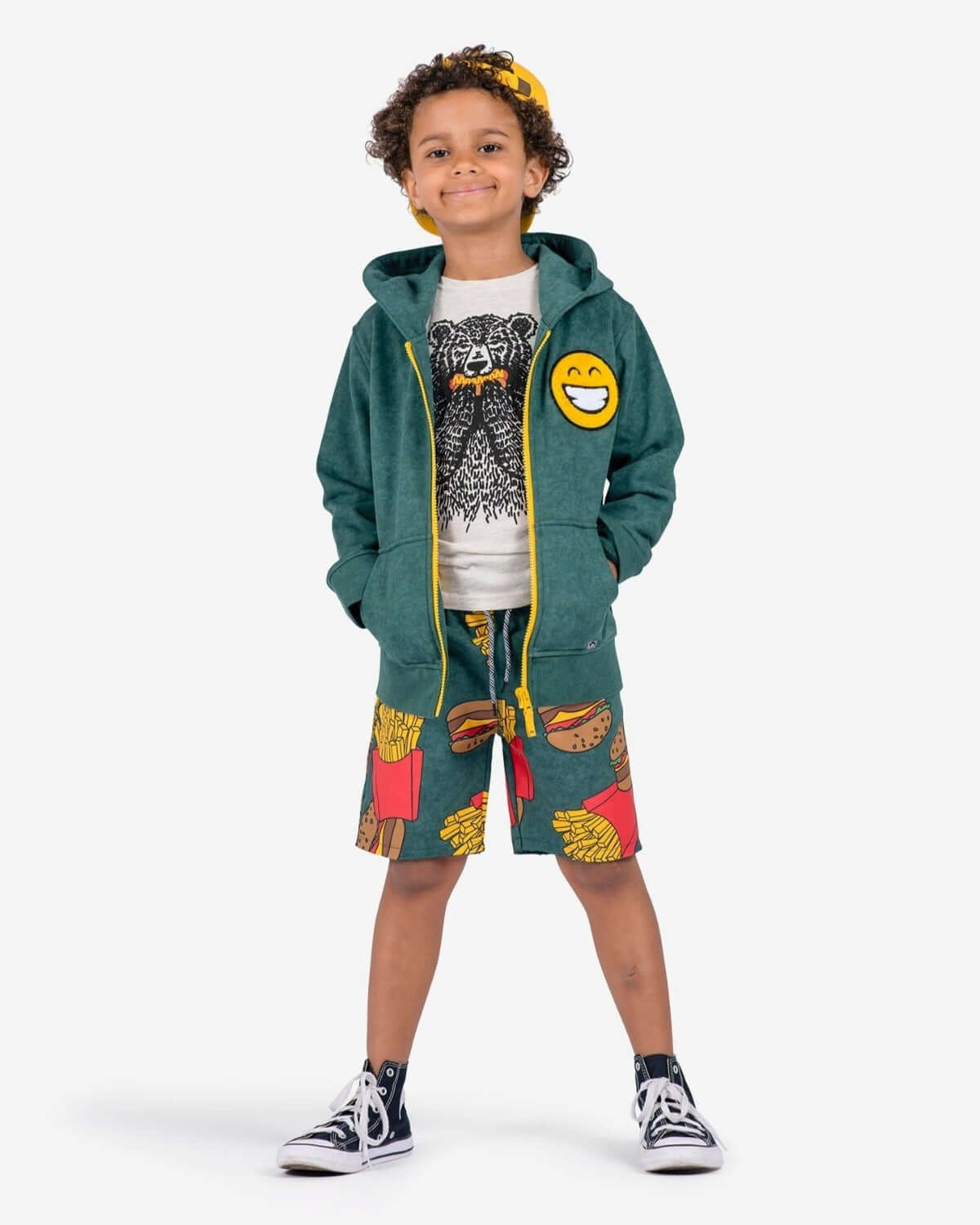 Dark Green Strivers Hoodie worn by a smiling child, styled with fun food-themed shorts.