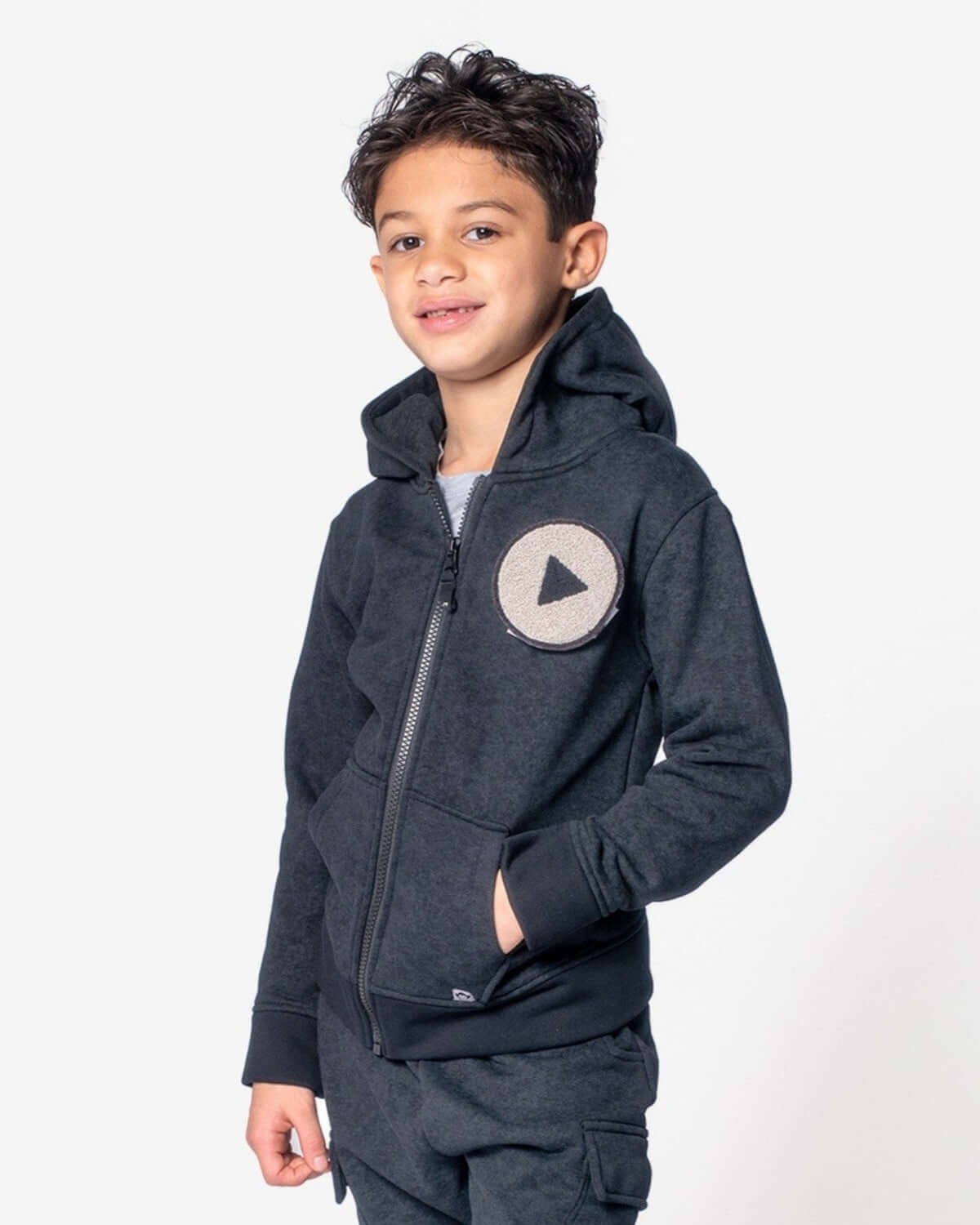 Stylish boy in grey Play Magic Zip Hoodie, ready for playground fun, showcasing high-quality kids clothes.