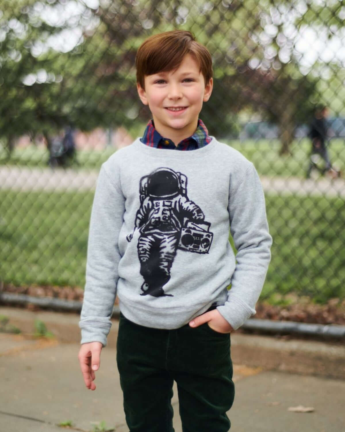 Stylish boy in a cozy Space Jams Revel Crewneck, perfect kids clothes for back to school adventures.